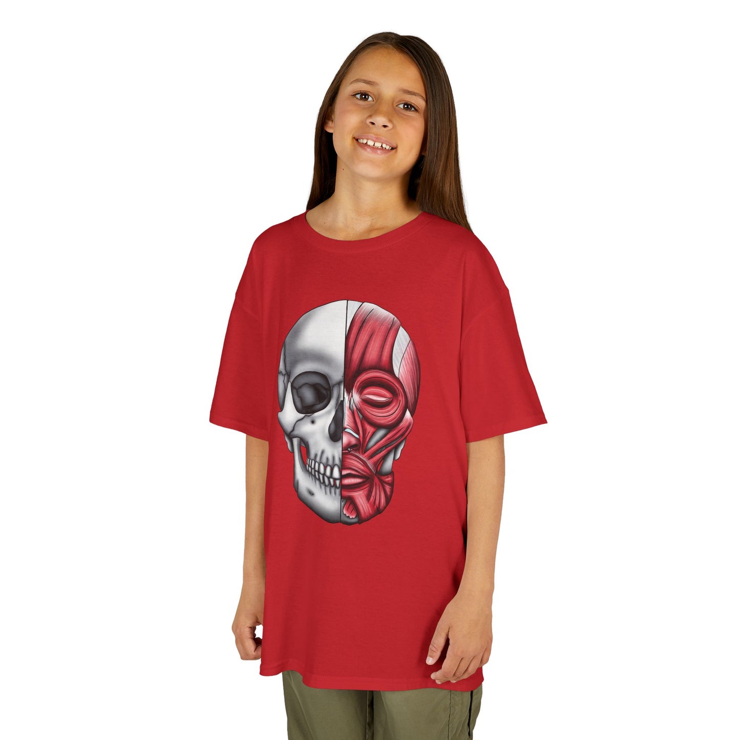 A girl wearing a red kids' t-shirt featuring an anatomical drawing of a human skull, with facial muscles illustrated on one half of the skull.