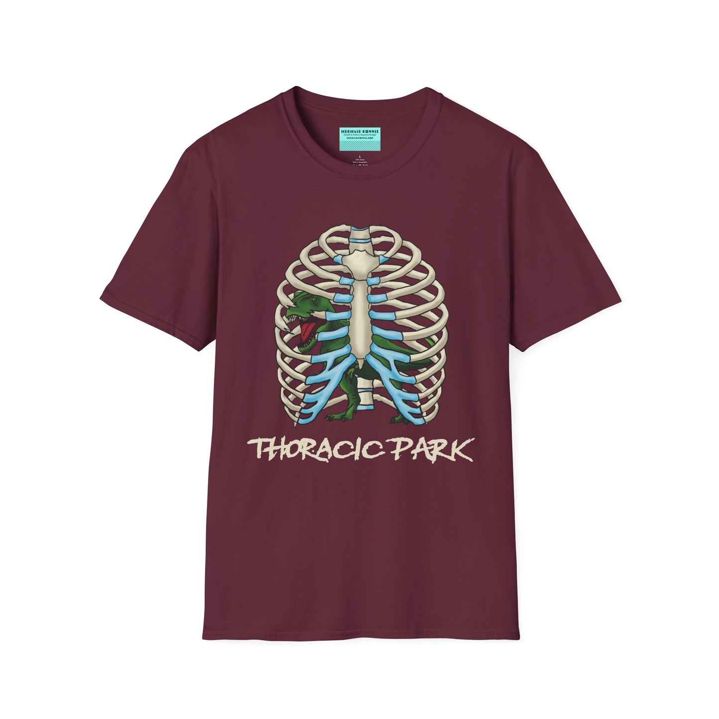 Burgundy unisex short sleeve tee with a clever Jurassic twist—an anatomical rib cage doubles as a prehistoric prison for a tiny T-Rex, with the punny caption "Thoracic Park" below. It's dino-mite meets anatomy class in the best way possible.
