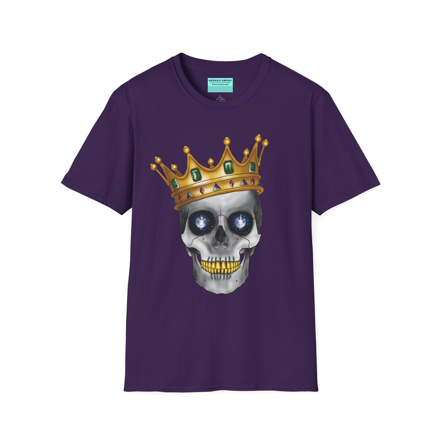 Purple t-shirt featuring an anatomical skull wearing an ornate crown, with gold teeth, large sapphire gemstones in the eye sockets, and emeralds and rubies decorating the crown.