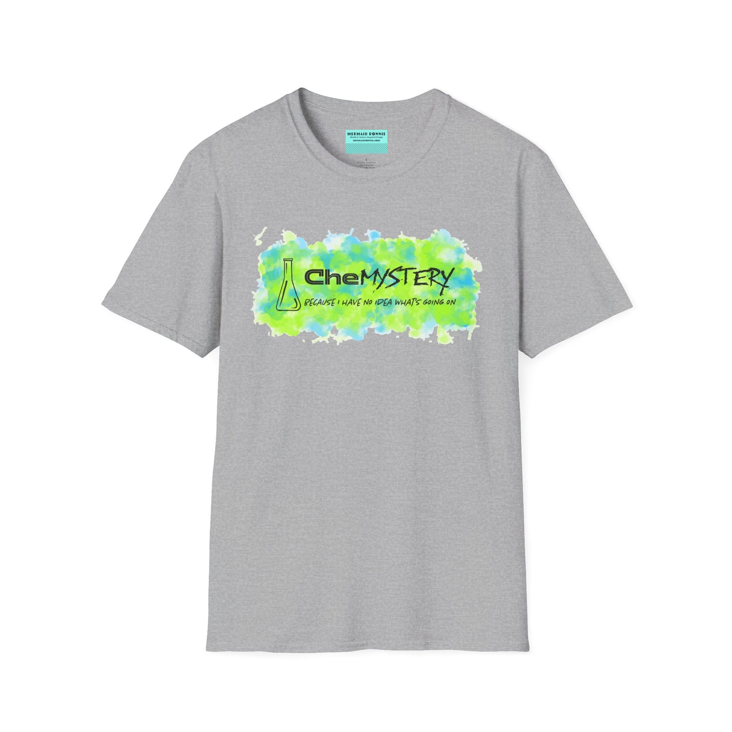 Light grey short-sleeve unisex t-shirt with playful watercolor-style blue and green splotches, a simple line-drawn beaker, and the witty phrase “CheMystery: because I have no idea what’s going on”—perfect for anyone who’s ever been personally victimized by the periodic table.