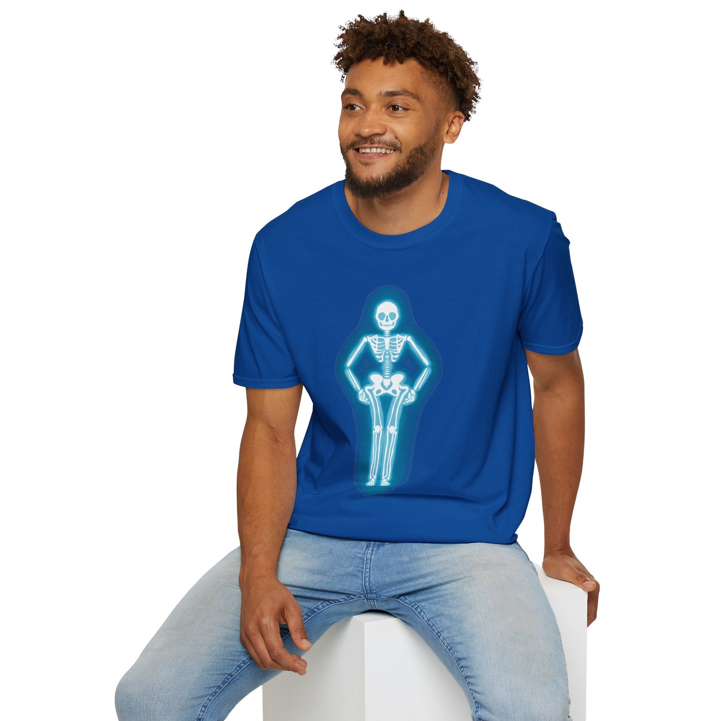 Man wearing a blue t-shirt featuring an illustration of a glowing neon sign in the shape of a skeleton.