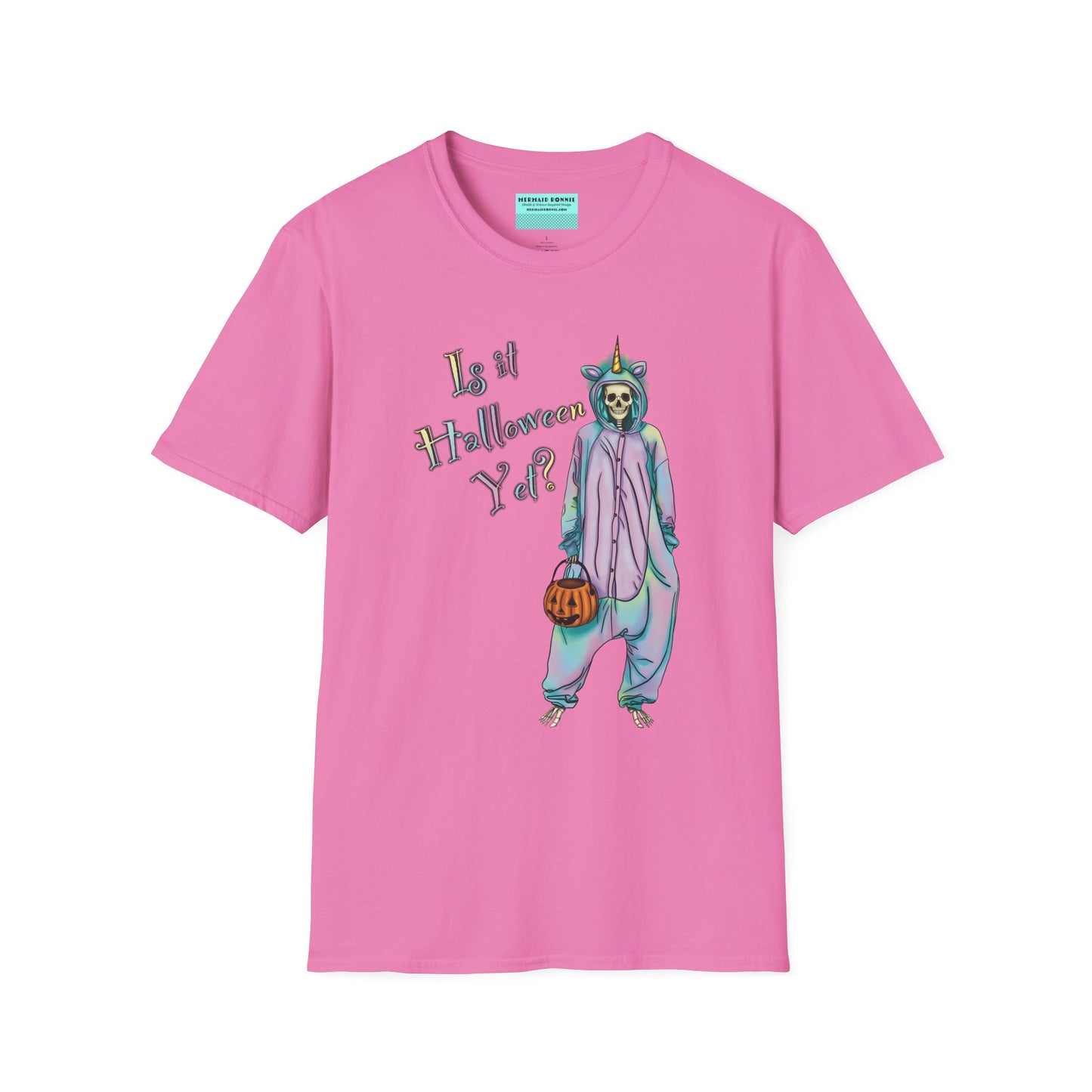 Pink t-shirt featuring a drawing of a skeleton in a unicorn costume onesie, with the phrase 'Is it Halloween yet?' printed on it.