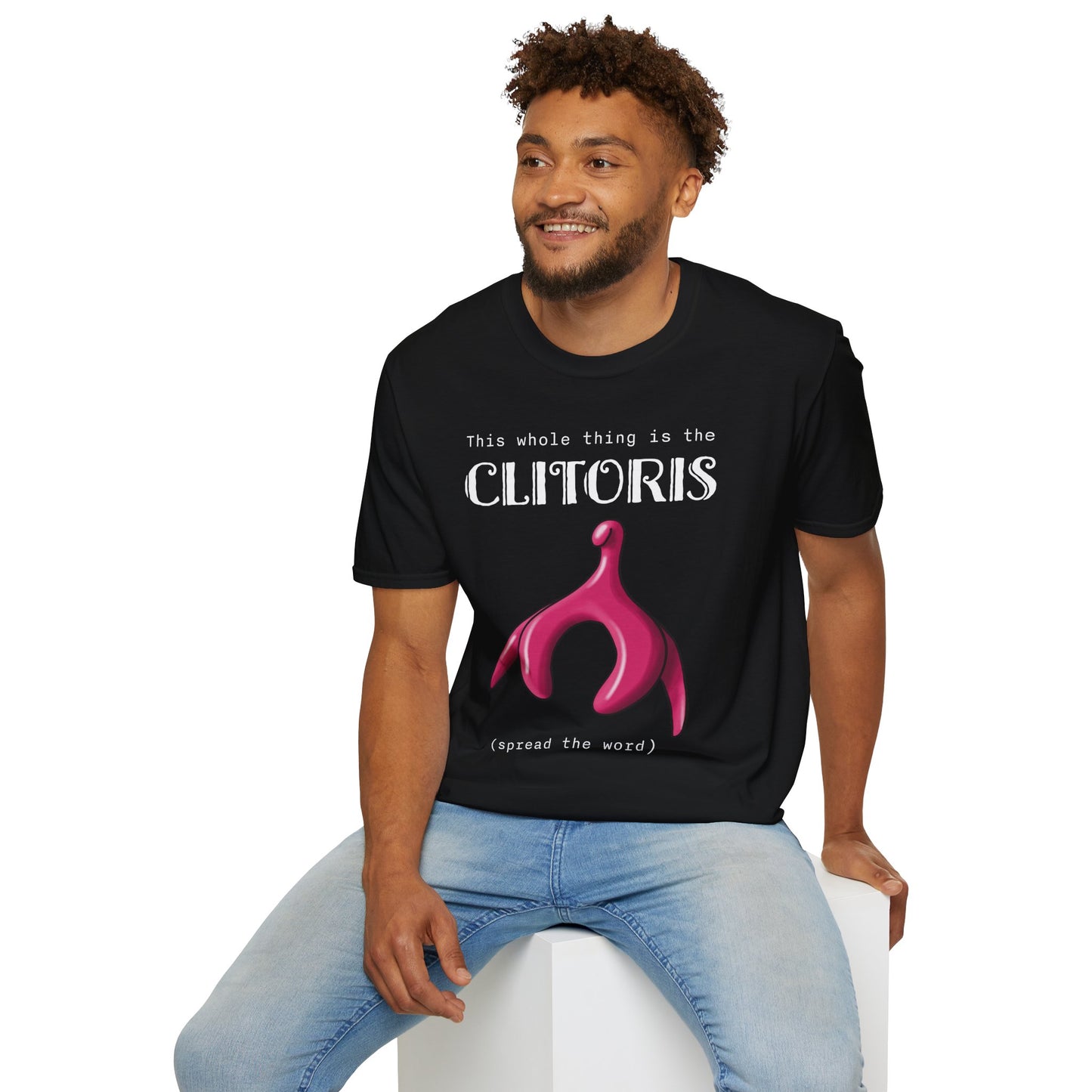 Man wearing a black t-shirt with an illustration of the clitoris and white text that reads 'this whole thing is the clitoris. spread the word’.