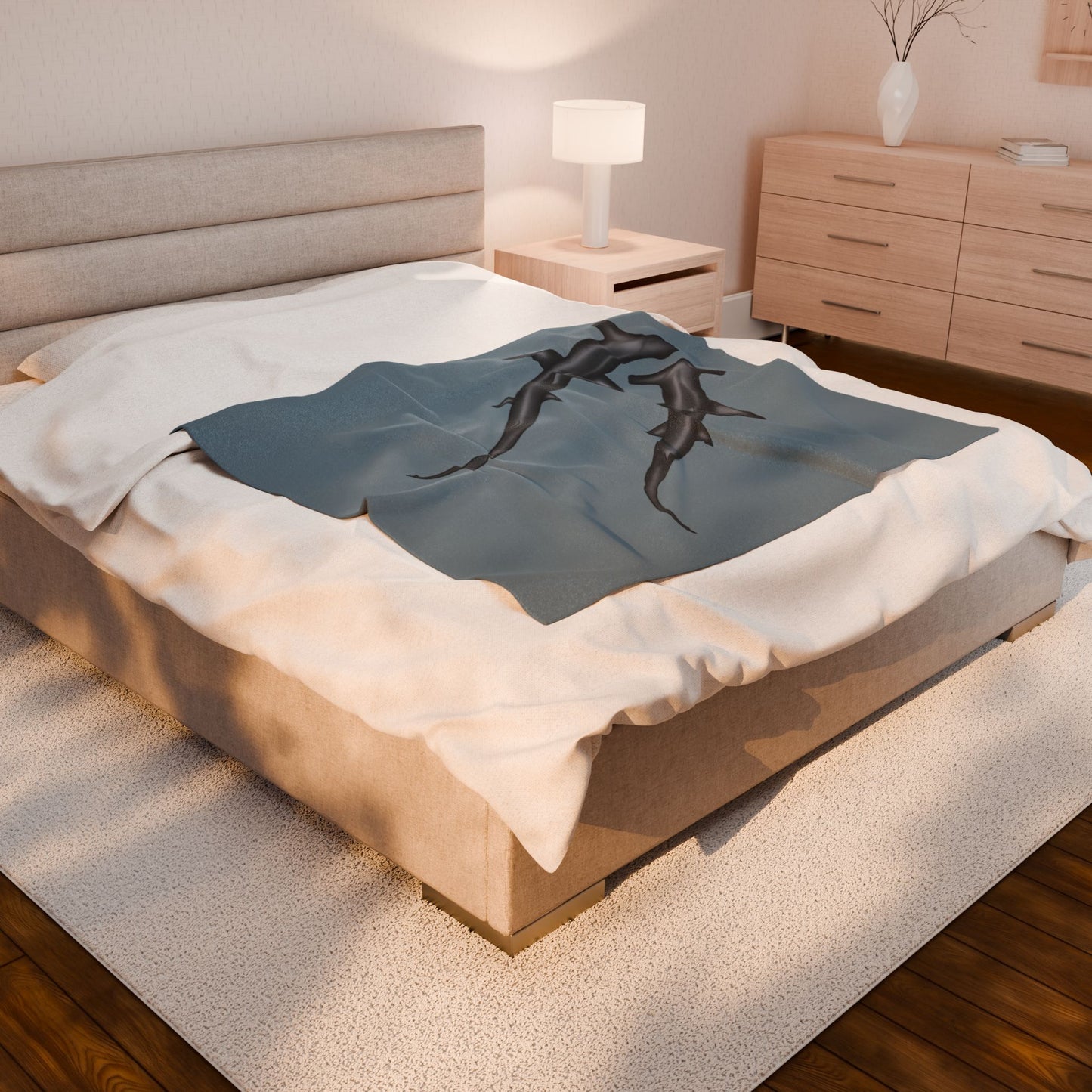 A medium blue-grey velveteen plush blanket featuring two hammerhead sharks gliding through the fabric like it's their personal ocean—perfect for wrapping yourself in comfort with a side of bite. Shown on a queen size bed.