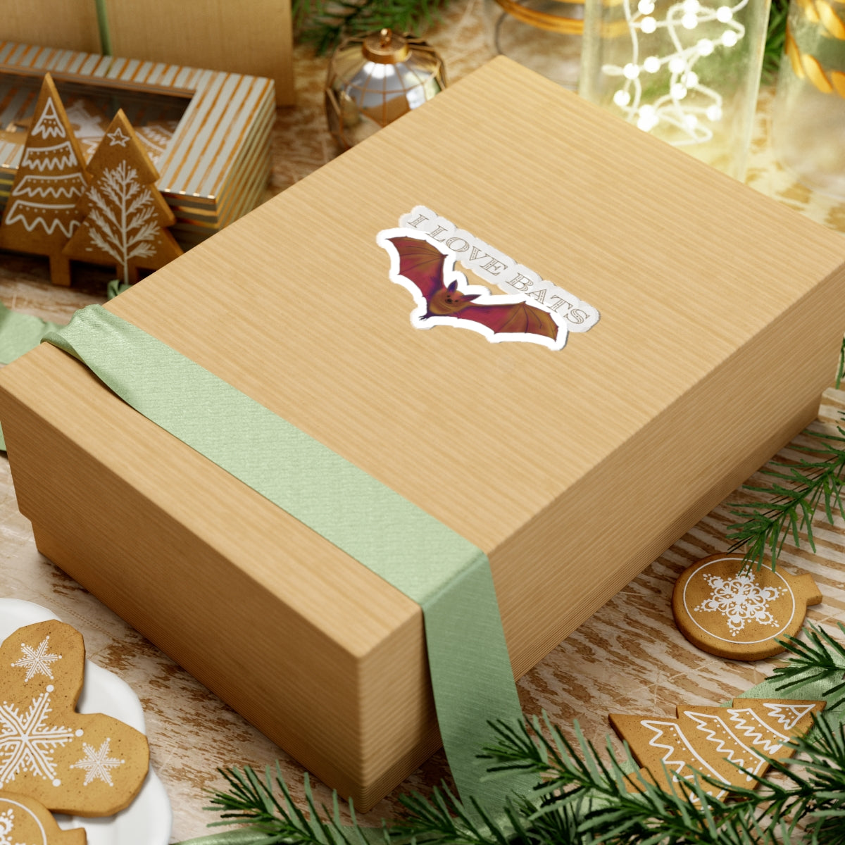 Small sticker featuring a drawing of a brown bat in flight with text that says 'I love bats.' The sticker is adhered to a gift
