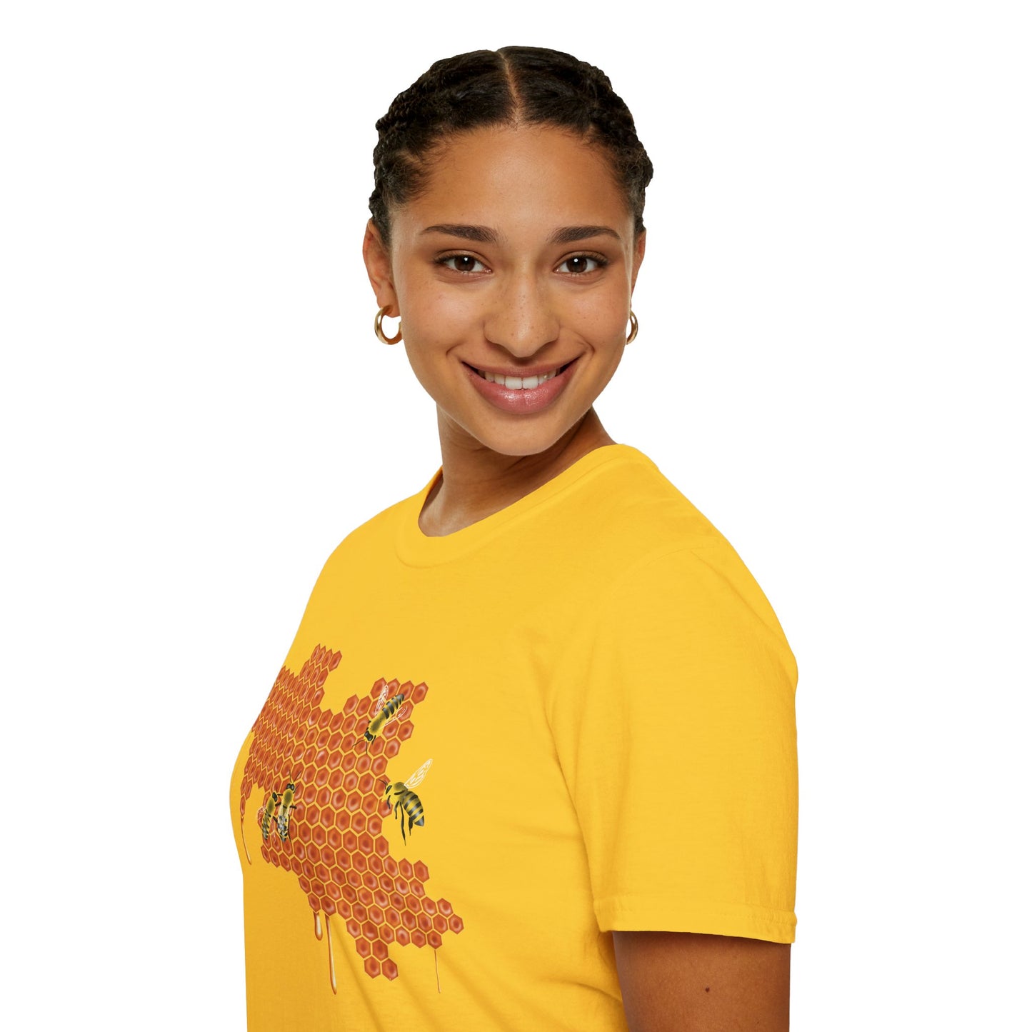 Woman wearing a yellow shirt featuring a picture of honeybees buzzing around a large piece of honeycomb with honey dripping down from it.