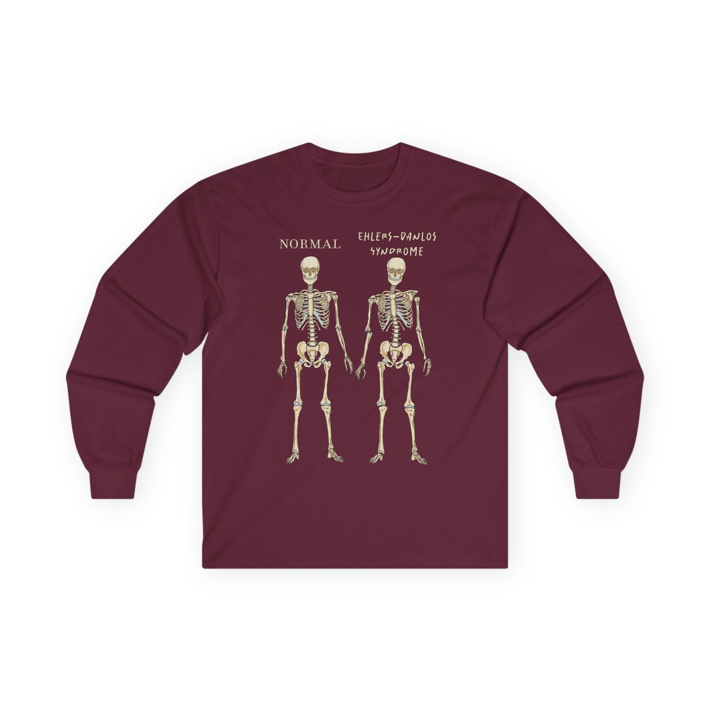 A burgundy long sleeve shirt with two skeletons side by side—one labeled "normal," the other "Ehlers-Danlos Syndrome"—visually showcasing the effects of EDS with a clever, anatomy-inspired twist.