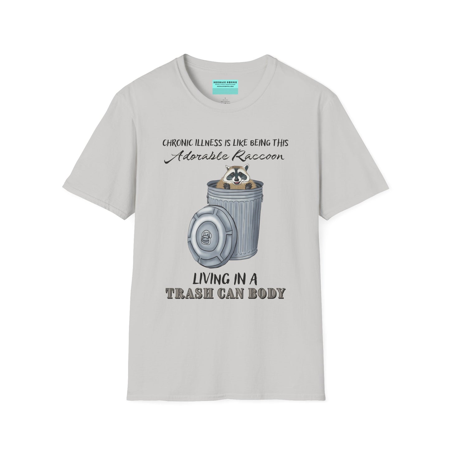 Grey t-shirt featuring an illustration of a raccoon in a metal trash can, with the phrase 'Chronic illness is like being this adorable raccoon living in a trash can body' printed on it.