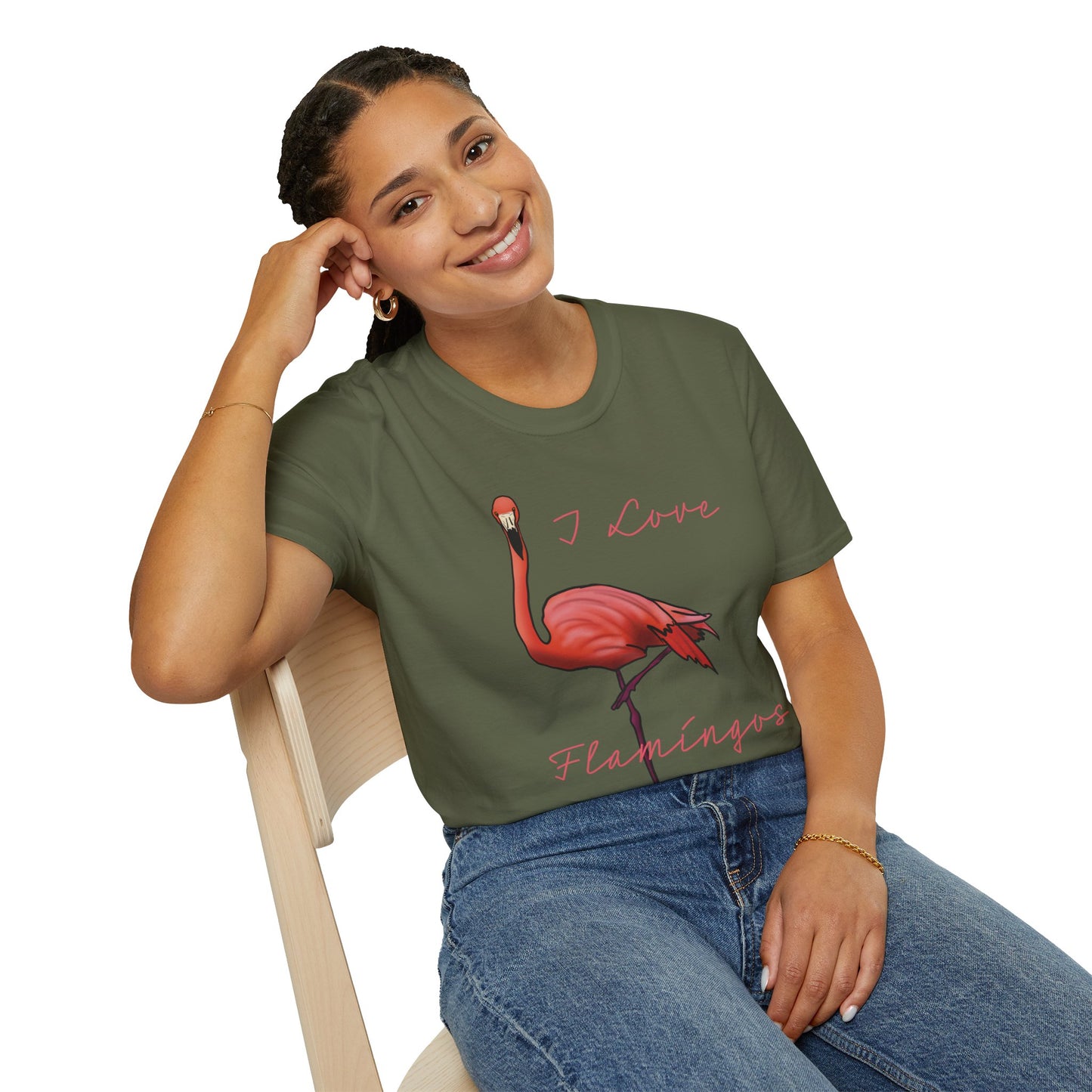 Woman wearing a green unisex short-sleeve tee with a fabulously pink flamingo strutting its stuff and the words “I love flamingos” — for anyone whose spirit animal stands on one leg.