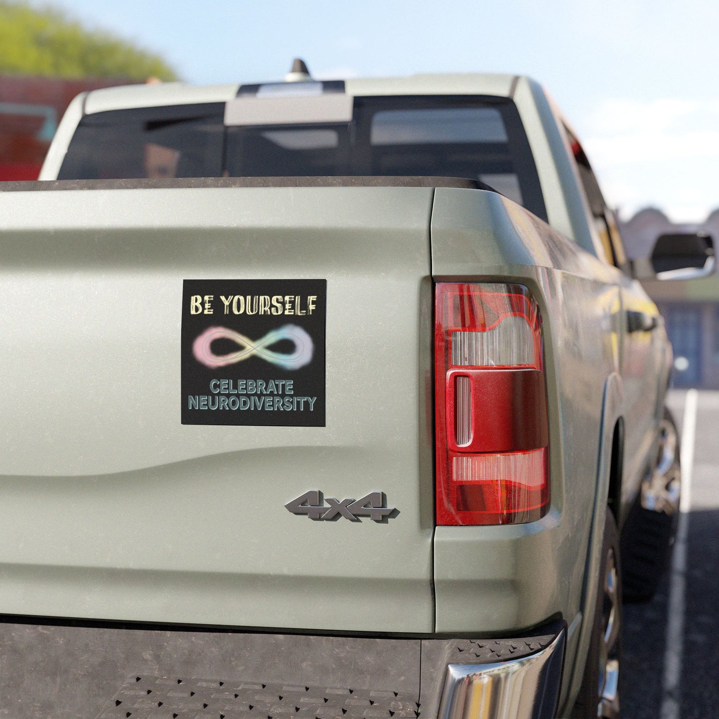 Black magnet on a pick-up truck with a pastel-colored infinity symbol and text that reads 'Be yourself, celebrate neurodiversity.'