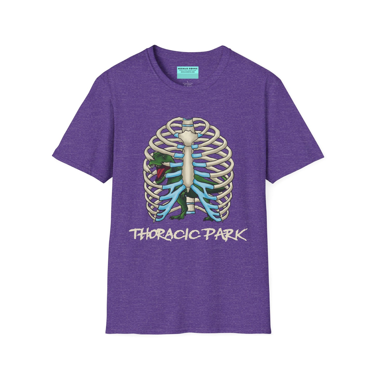 Purple unisex short sleeve tee with a clever Jurassic twist—an anatomical rib cage doubles as a prehistoric prison for a tiny T-Rex, with the punny caption "Thoracic Park" below. It's dino-mite meets anatomy class in the best way possible.