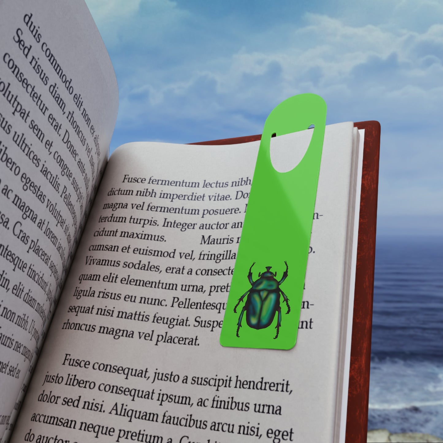Lime green aluminum bookmark clipped in a book featuring a detailed illustration of a June bug (green chafer beetle), its iridescent body gleaming against the vibrant background.