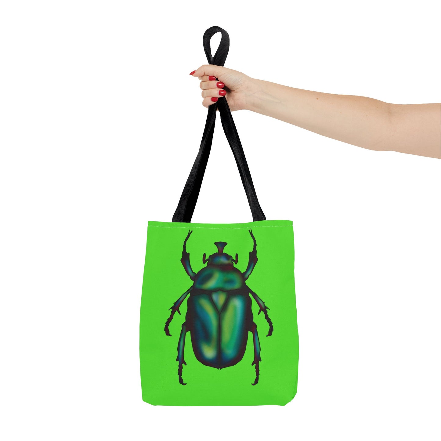 Small lime green tote bag with a black handle in a woman’s hand held out to the side featuring an illustration of a June bug (green chafer beetle).
