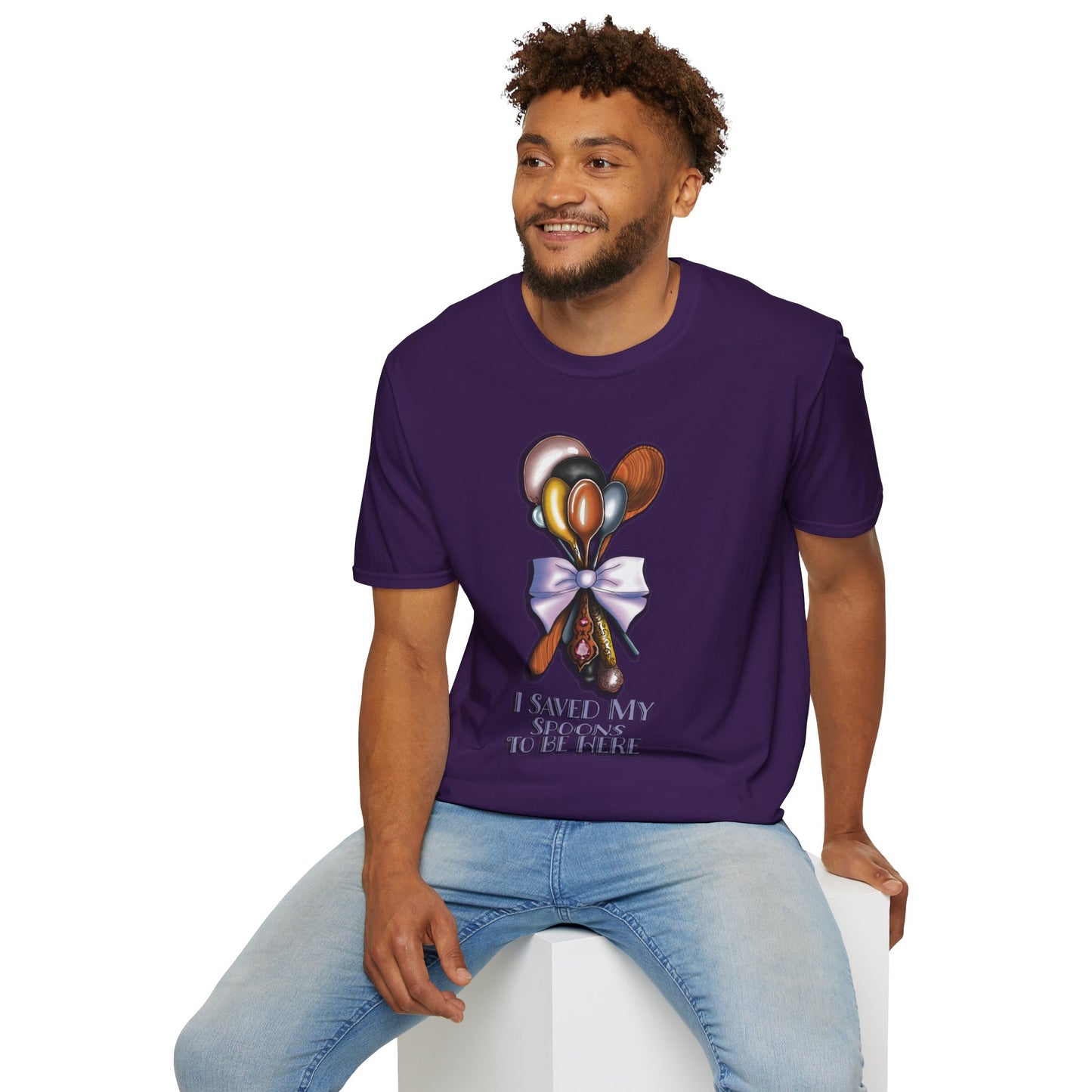Man wearing a purple t-shirt featuring a bouquet of spoons illustration and the phrase 'I saved my spoons to be here' on the front.