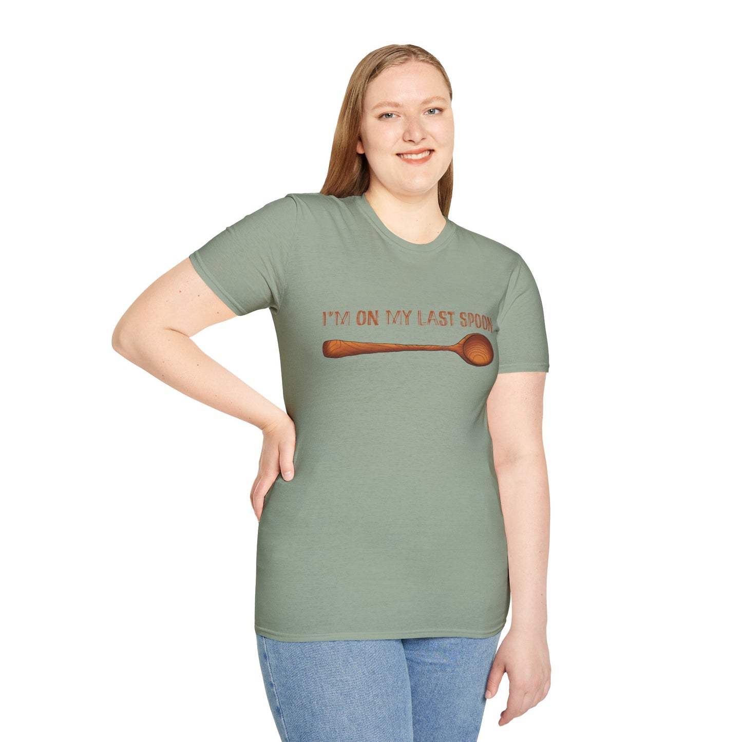 Woman wearing a green t-shirt with an illustration of a single wooden spoon and the phrase 'I'm on my last spoon' printed on the front.