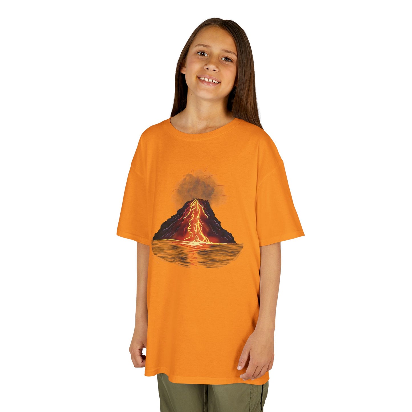 A girl wearing an orange kid's t-shirt featuring a fiery illustration of an erupting volcano—because even the most explosive adventures start with a great outfit!