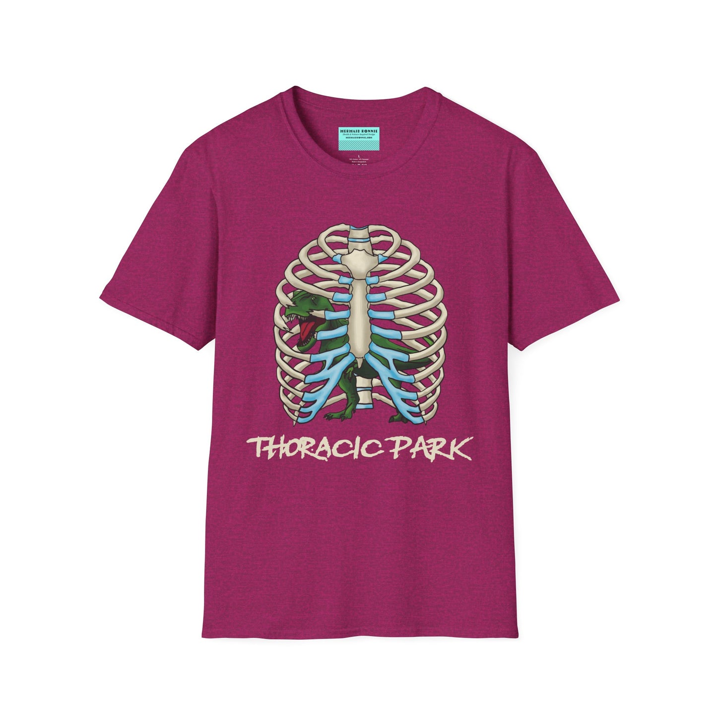 Pink unisex short sleeve tee with a clever Jurassic twist—an anatomical rib cage doubles as a prehistoric prison for a tiny T-Rex, with the punny caption "Thoracic Park" below. It's dino-mite meets anatomy class in the best way possible.