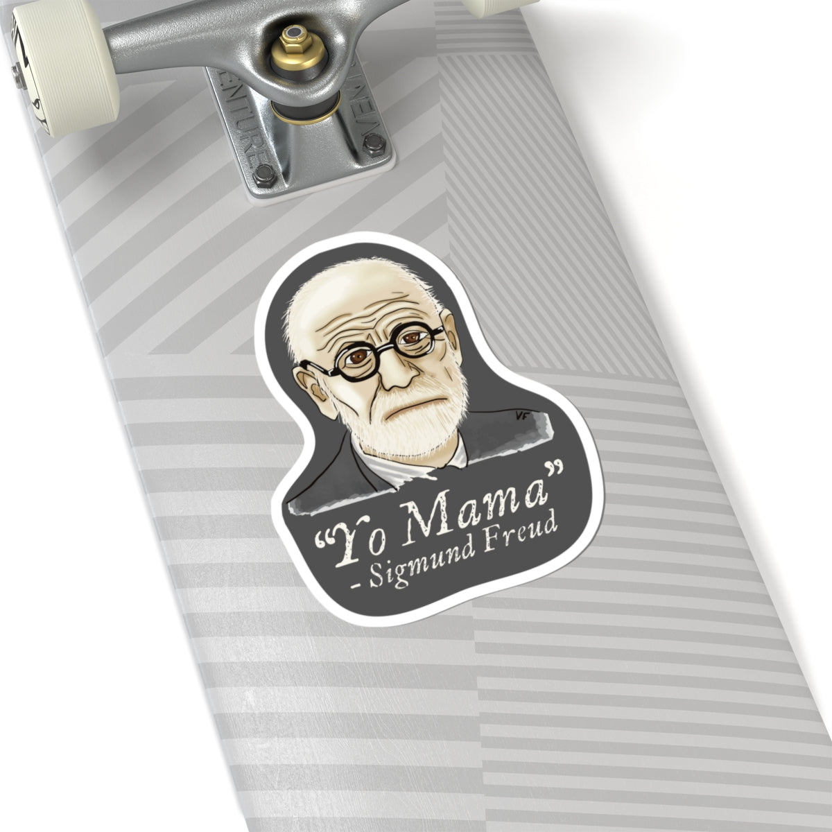 Large sticker adhered to a skateboard featuring a portrait of Sigmund Freud with the humorous quote 'yo mama' written below him.