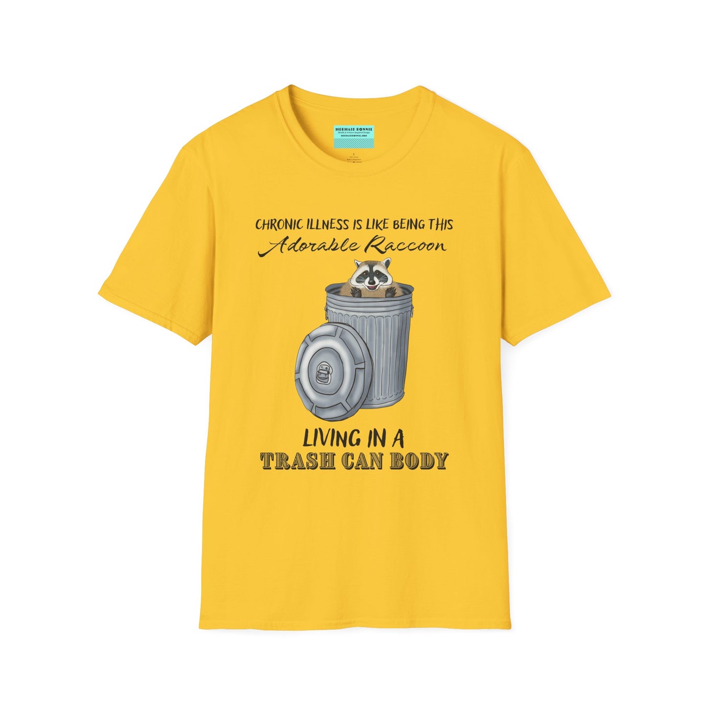 Yellow t-shirt featuring an illustration of a raccoon in a metal trash can, with the phrase 'Chronic illness is like being this adorable raccoon living in a trash can body' printed on it.
