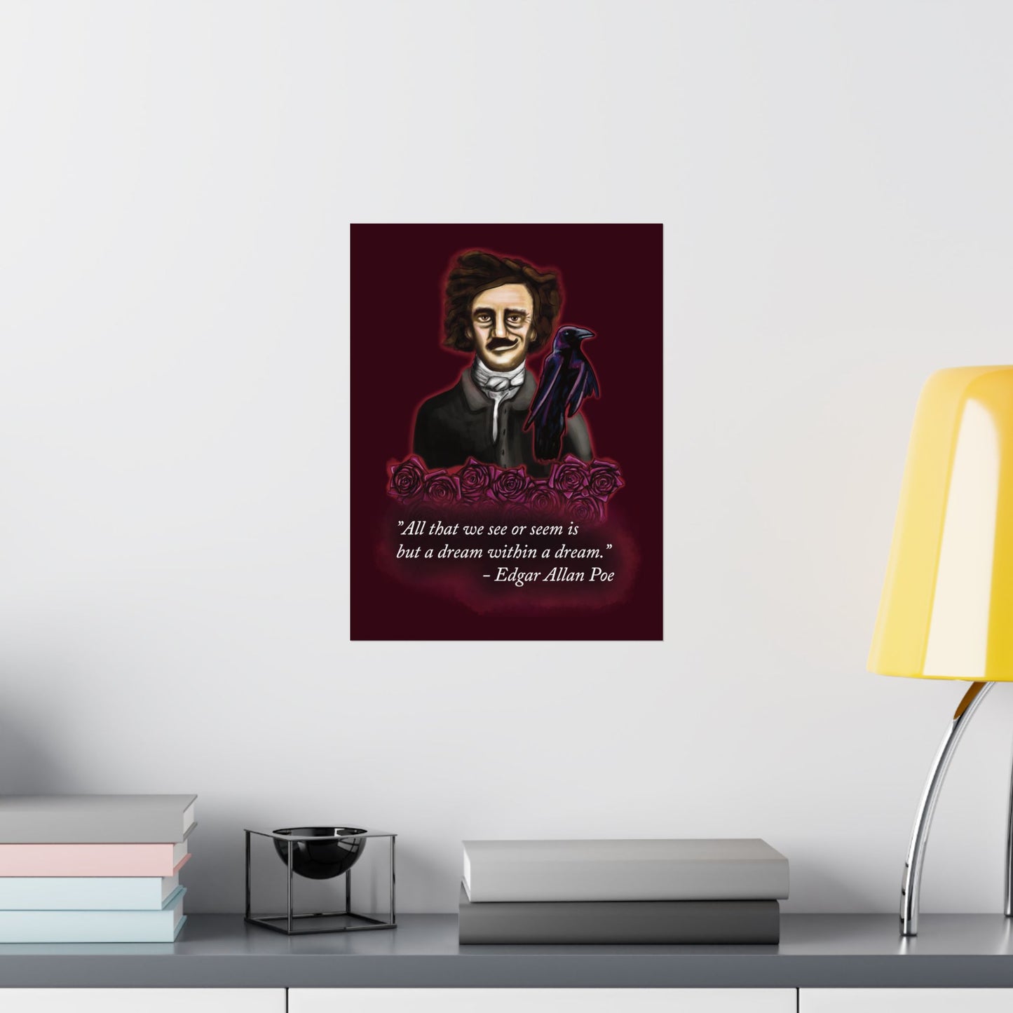 A medium moody poster of Edgar Allan Poe hung in an office setting. He is wearing a wry smile as he’s surrounded by crimson roses and a raven, with a rich burgundy background—because even the master of macabre has a soft spot for gothic romance.