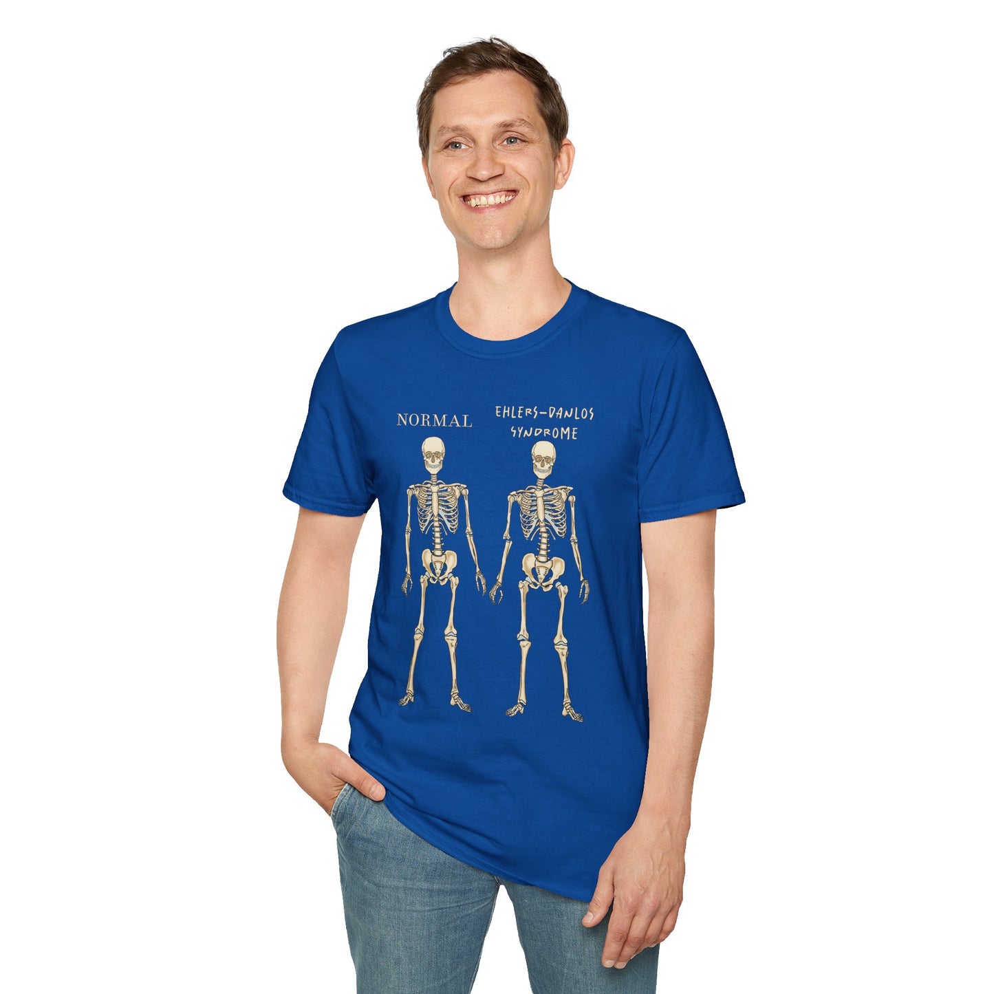 Man wearing a royal blue unisex short sleeve t-shirt featuring two skeletons side by side—one labeled "normal," the other "Ehlers-Danlos Syndrome"—because connective tissue disorders deserve more visibility (and maybe a sense of humor, too).