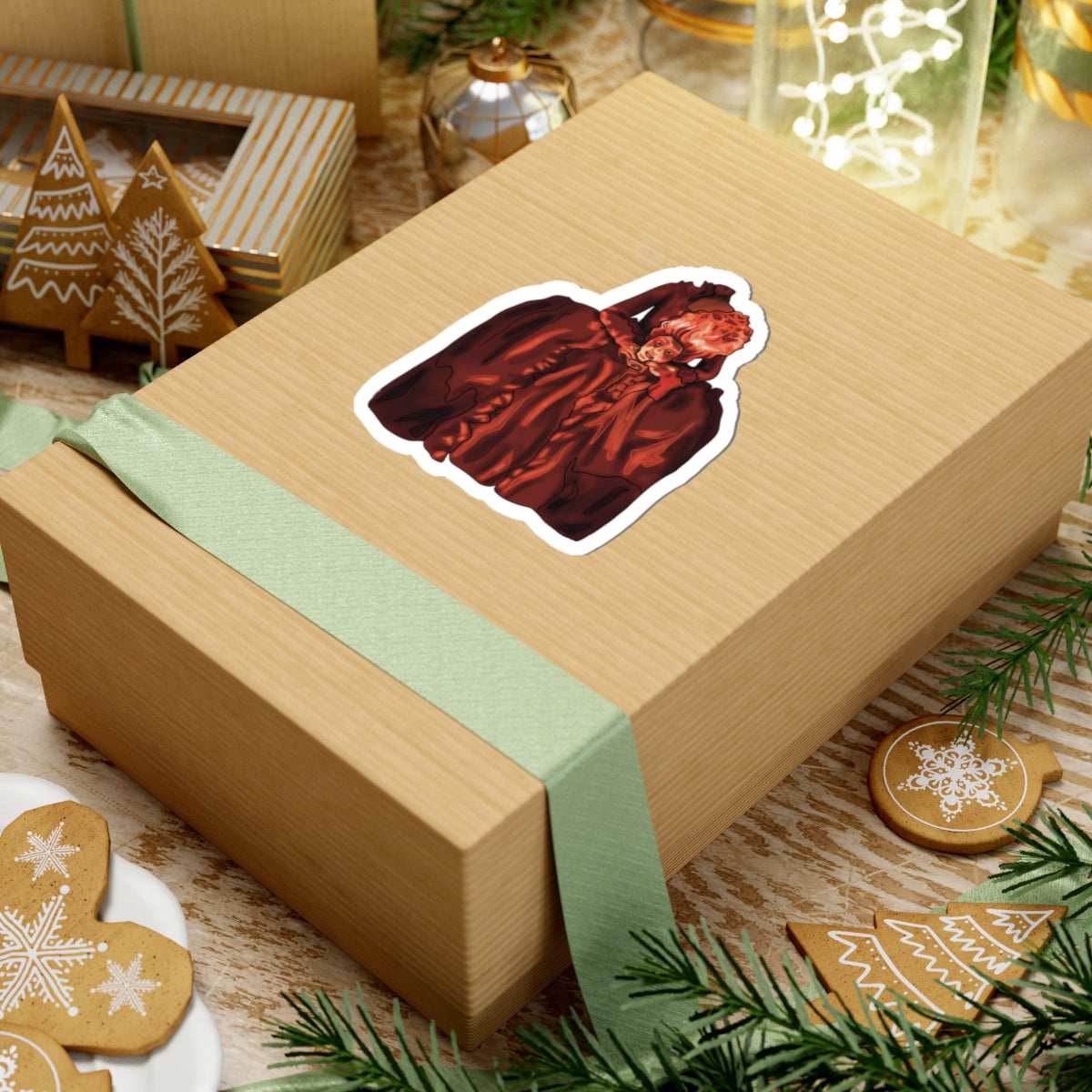 Medium sticker on a package featuring a drawing of Marie Antoinette dressed in red, holding her own head after beheading.