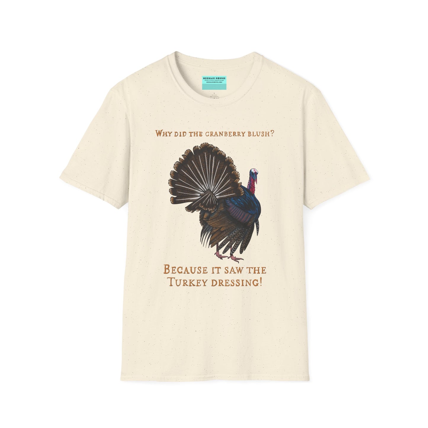 Beige Thanksgiving t-shirt featuring a picture of a turkey and the text 'Why did the cranberry blush? Because it saw the turkey dressing!