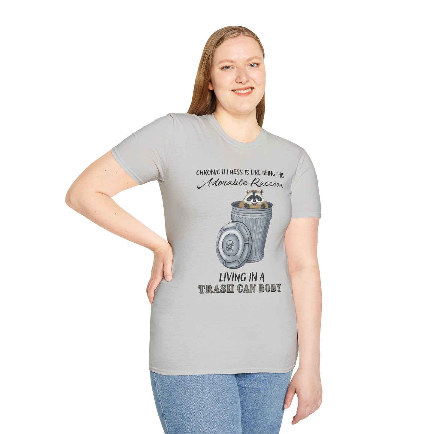 Woman wearing a grey t-shirt featuring a picture of a raccoon in a metal trash can, with the phrase 'Chronic illness is like being this adorable raccoon living in a trash can body' printed on it.
