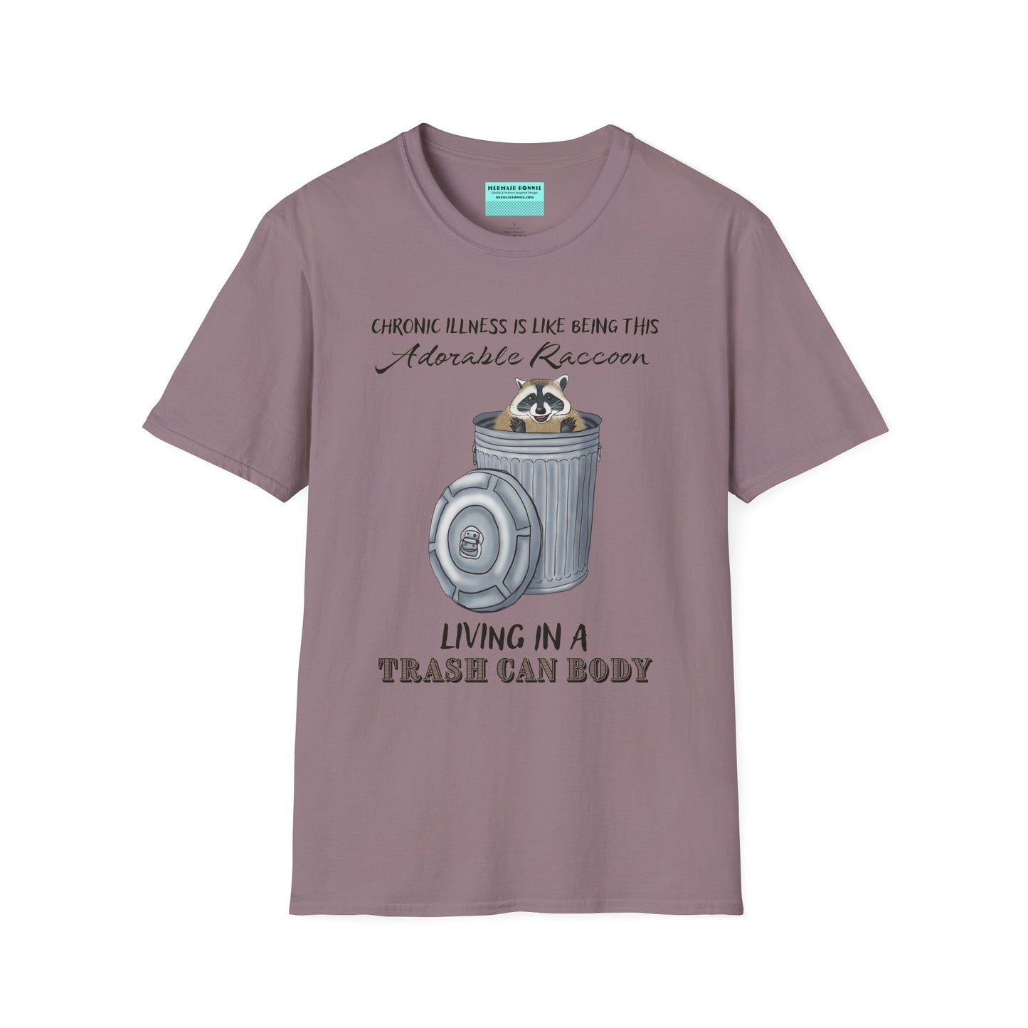 Purple t-shirt featuring an illustration of a raccoon in a metal trash can, with the phrase 'Chronic illness is like being this adorable raccoon living in a trash can body' printed on it.