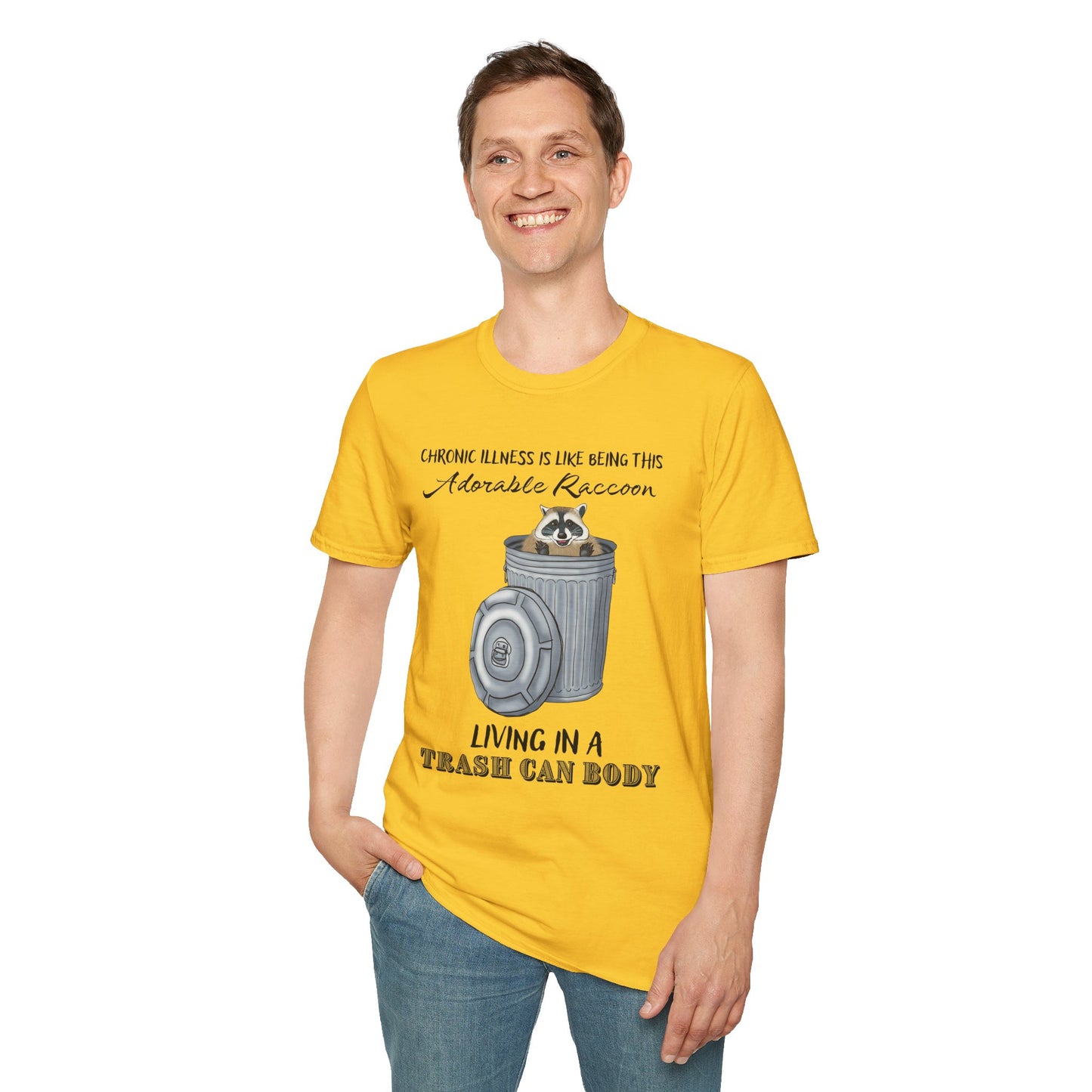 Man wearing a yellow t-shirt featuring a picture of a raccoon in a metal trash can, with the phrase 'Chronic illness is like being this adorable raccoon living in a trash can body' printed on it.