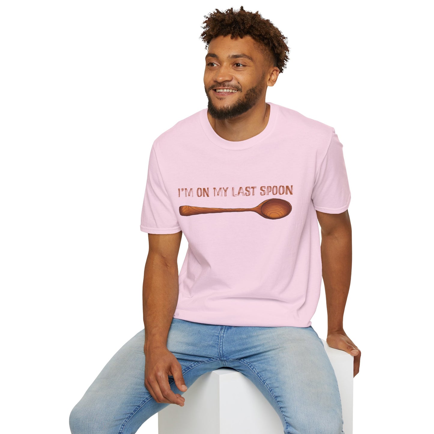 Man wearing a pink t-shirt with an illustration of a single wooden spoon and the phrase 'I'm on my last spoon' printed on the front.