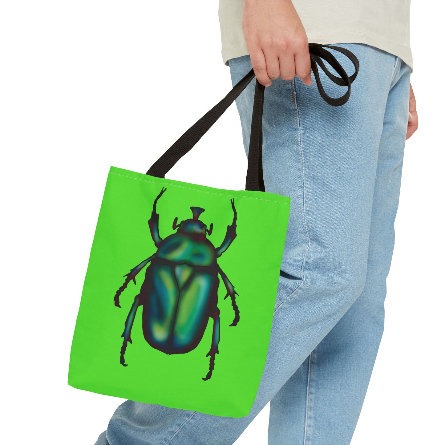 Small lime green tote bag with a black handle in a person's hand featuring an illustration of a June bug (green chafer beetle).