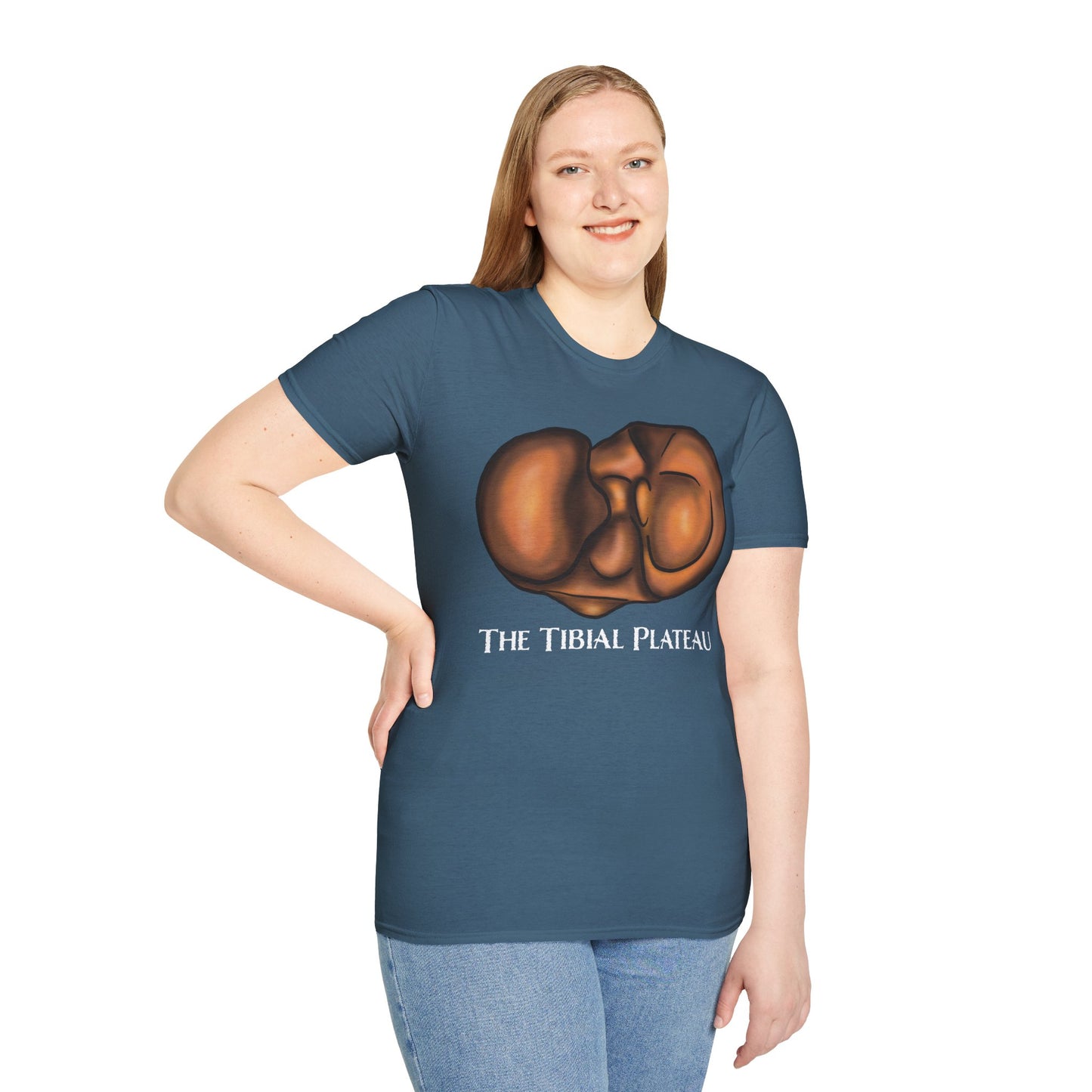 Woman wearing an indigo blue unisex short sleeve tee featuring a clever anatomical illustration of the tibial plateau, reimagined as a landscape with rolling hills—because who knew the tibia could be so scenic?