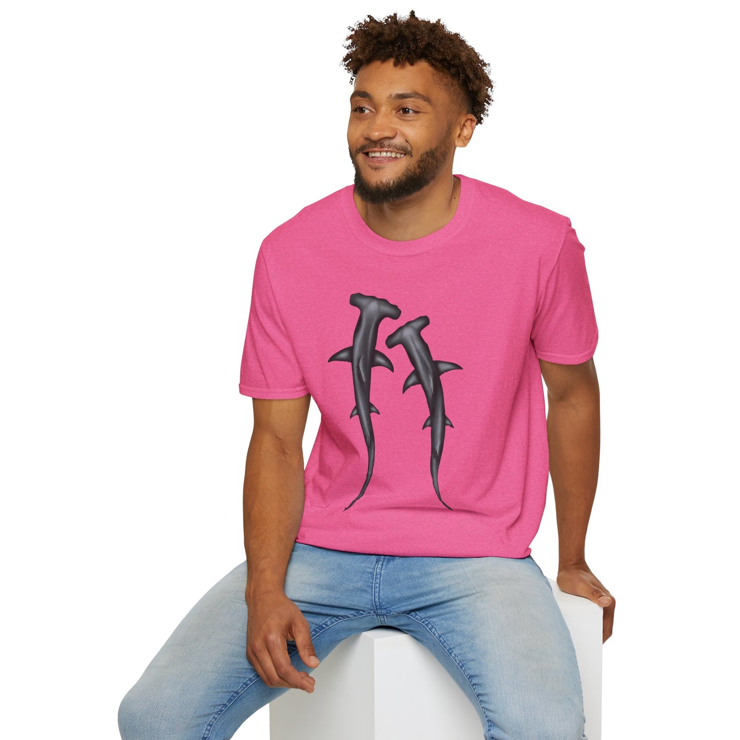 Man wearing a pink t-shirt featuring an illustration of two hammerhead sharks.
