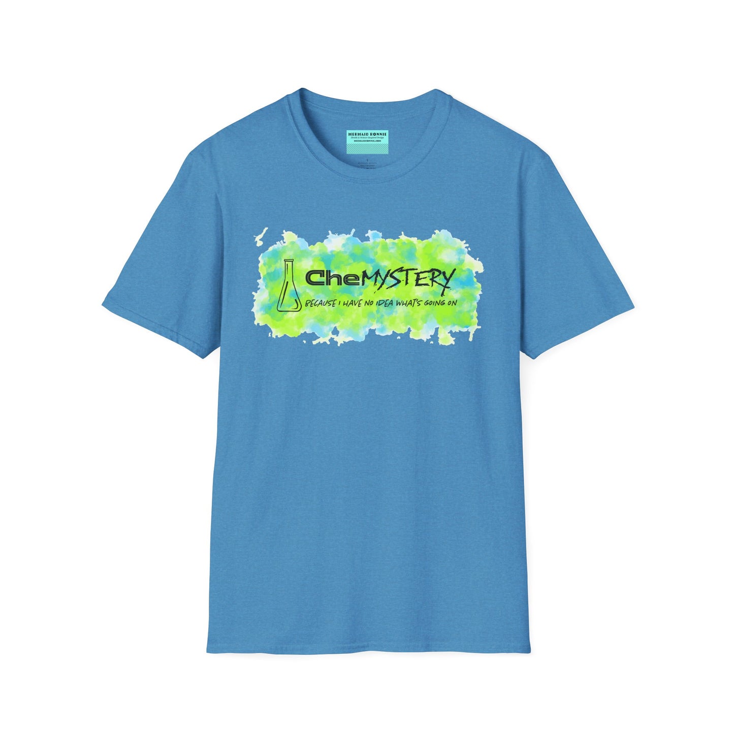 Medium blue short-sleeve unisex t-shirt with playful watercolor-style blue and green splotches, a simple line-drawn beaker, and the witty phrase “CheMystery: because I have no idea what’s going on”—perfect for anyone who’s ever been personally victimized by the periodic table.