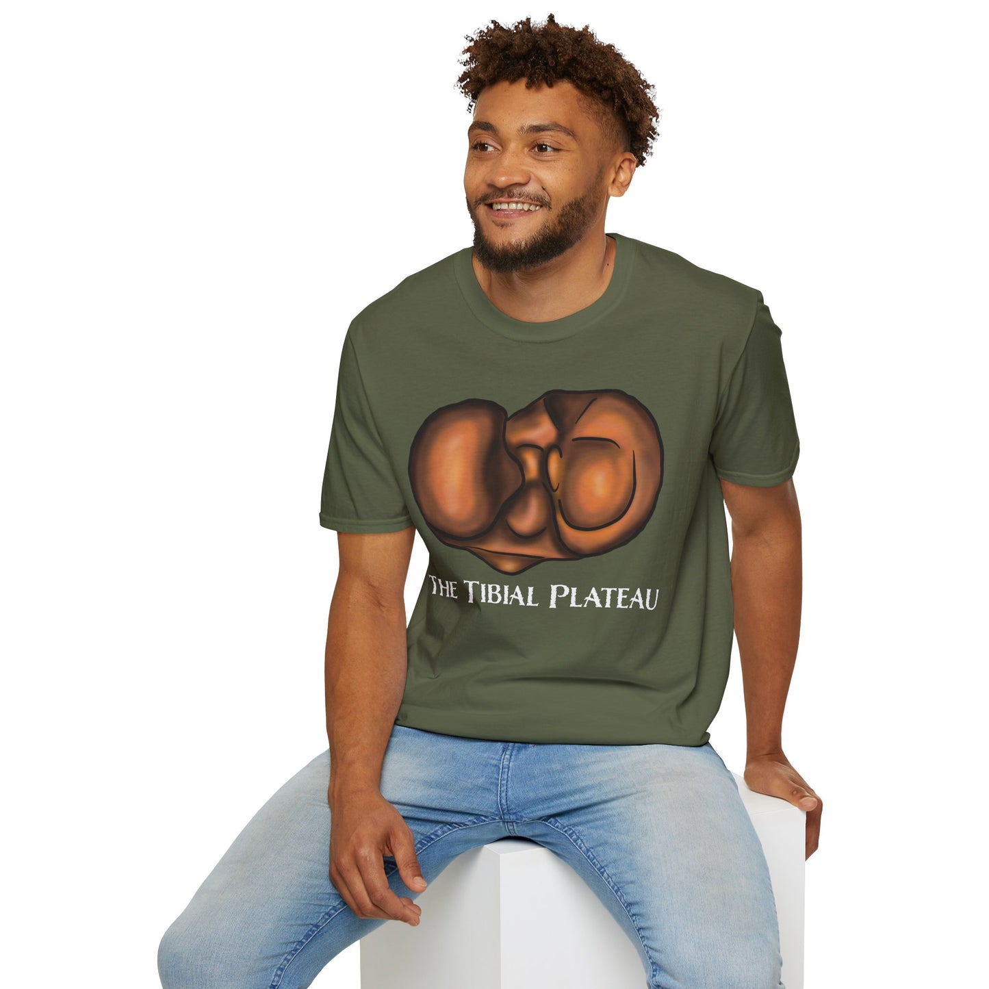 Man wearing a green unisex short sleeve tee featuring a clever anatomical illustration of the tibial plateau, reimagined as a landscape with rolling hills—because who knew the tibia could be so scenic?