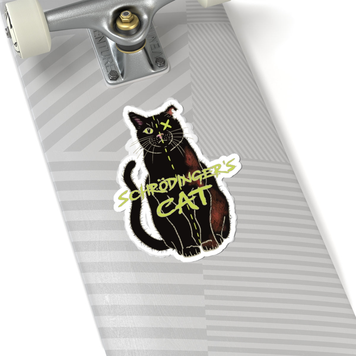 Large sticker adhered to a skateboard featuring a black cat with one half depicted as alive and the other half as dead, with an X over one eye, representing Schrödinger's cat.