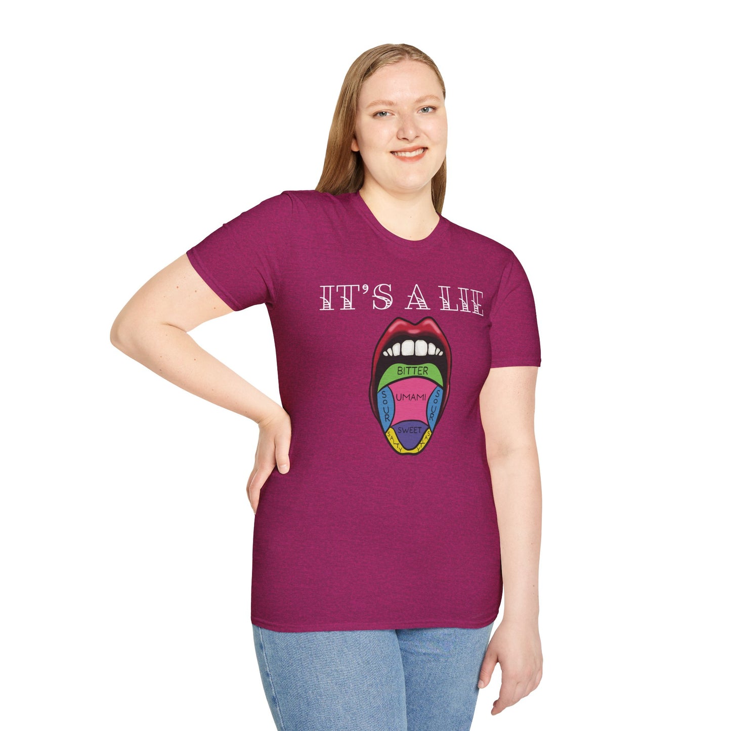 Woman wearing a pink short-sleeve unisex t-shirt featuring a classic tongue taste map with the words “It’s a lie” boldly above it—busting the myth that different parts of your tongue taste different things. Sweet, salty, sour, bitter? Taste buds don’t discriminate!