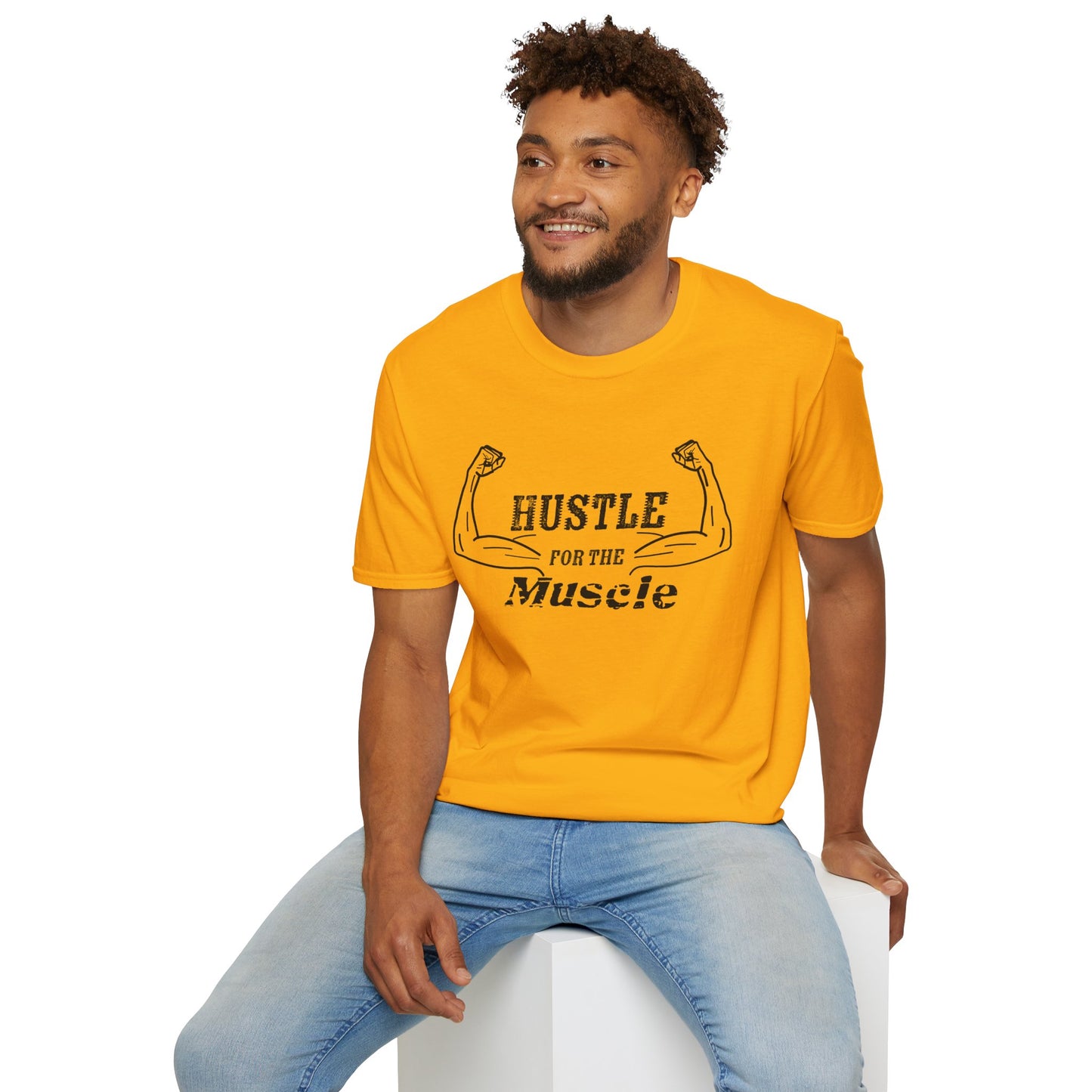 Man wearing a yellow unisex short sleeve t-shirt with a bold graphic of strong, flexed feminine arms and the empowering phrase "Hustle for the Muscle"—because strength is stylish and lifting is for everyone.