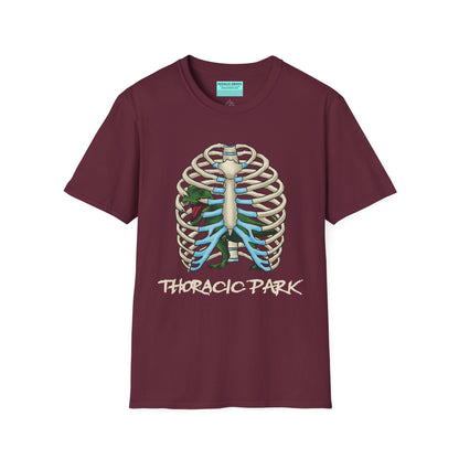 Burgundy unisex short sleeve tee with a clever Jurassic twist—an anatomical rib cage doubles as a prehistoric prison for a tiny T-Rex, with the punny caption "Thoracic Park" below. It's dino-mite meets anatomy class in the best way possible.