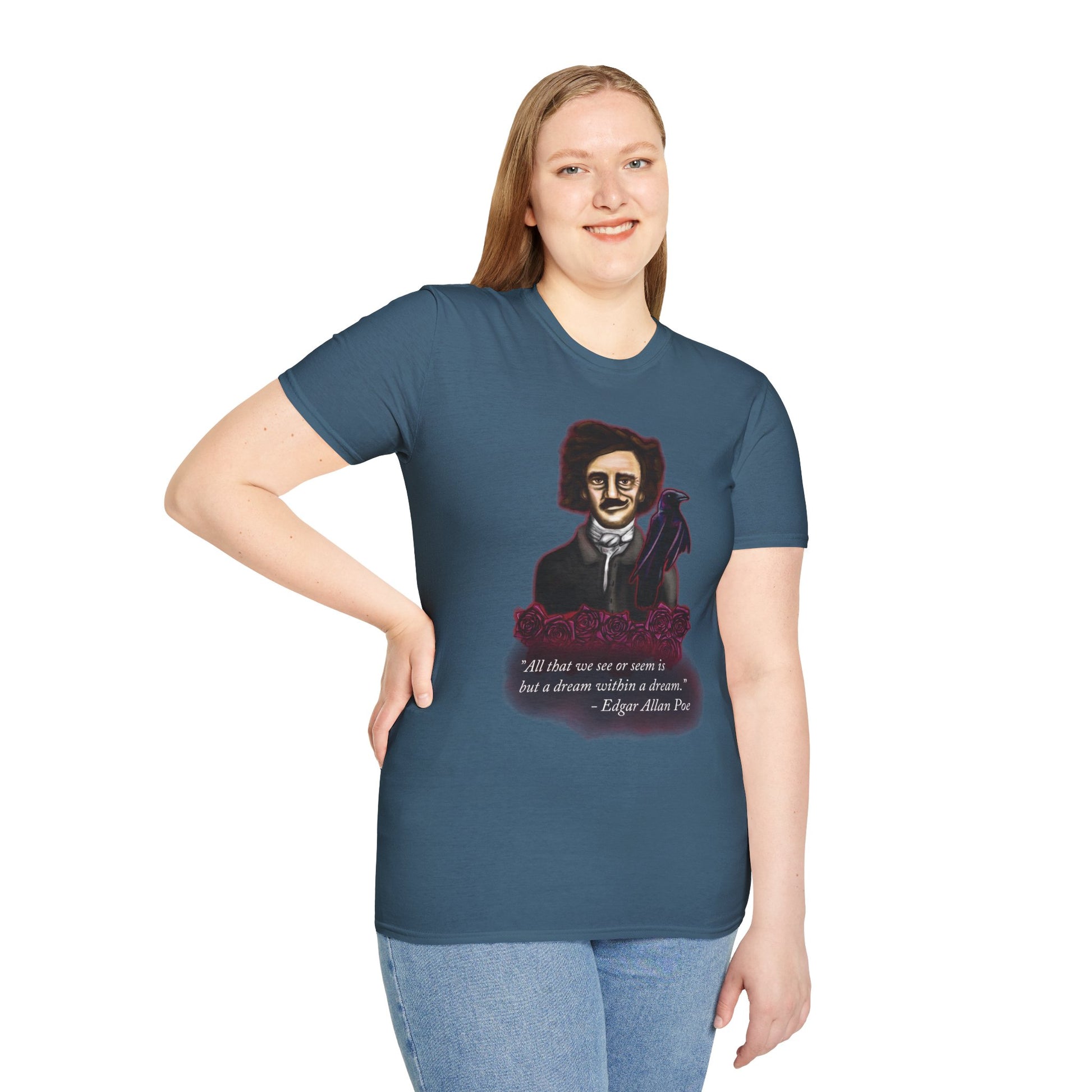 Woman wearing a blue t-shirt featuring a drawing of Edgar Allan Poe with a raven perched nearby and red roses surrounding them, along with the quote 'All that we see or seem is but a dream within a dream.'