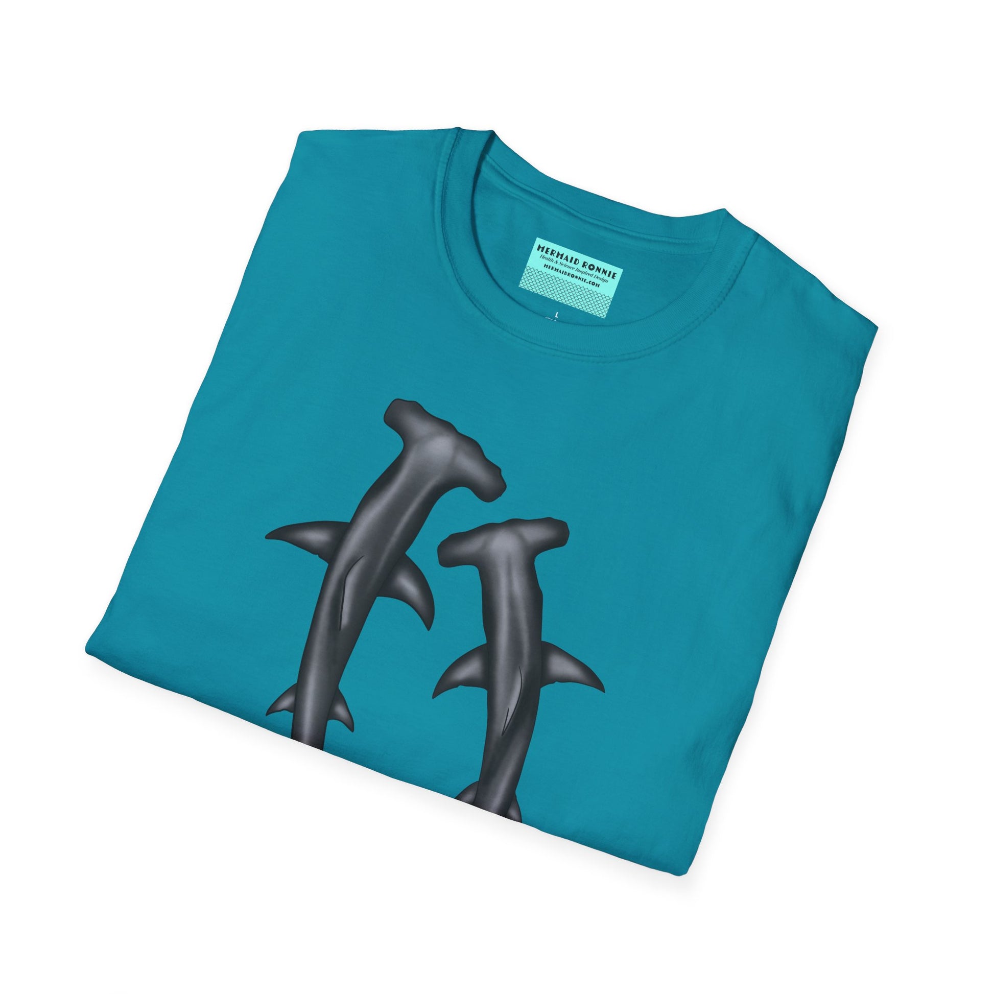 Folded blue t-shirt featuring an illustration of two hammerhead sharks.