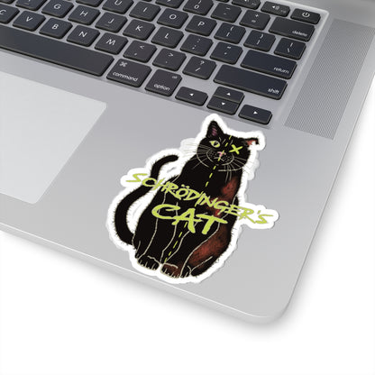 Medium sticker adhered to computer featuring a black cat with one half depicted as alive and the other half as dead, with an X over one eye, representing Schrödinger's cat.