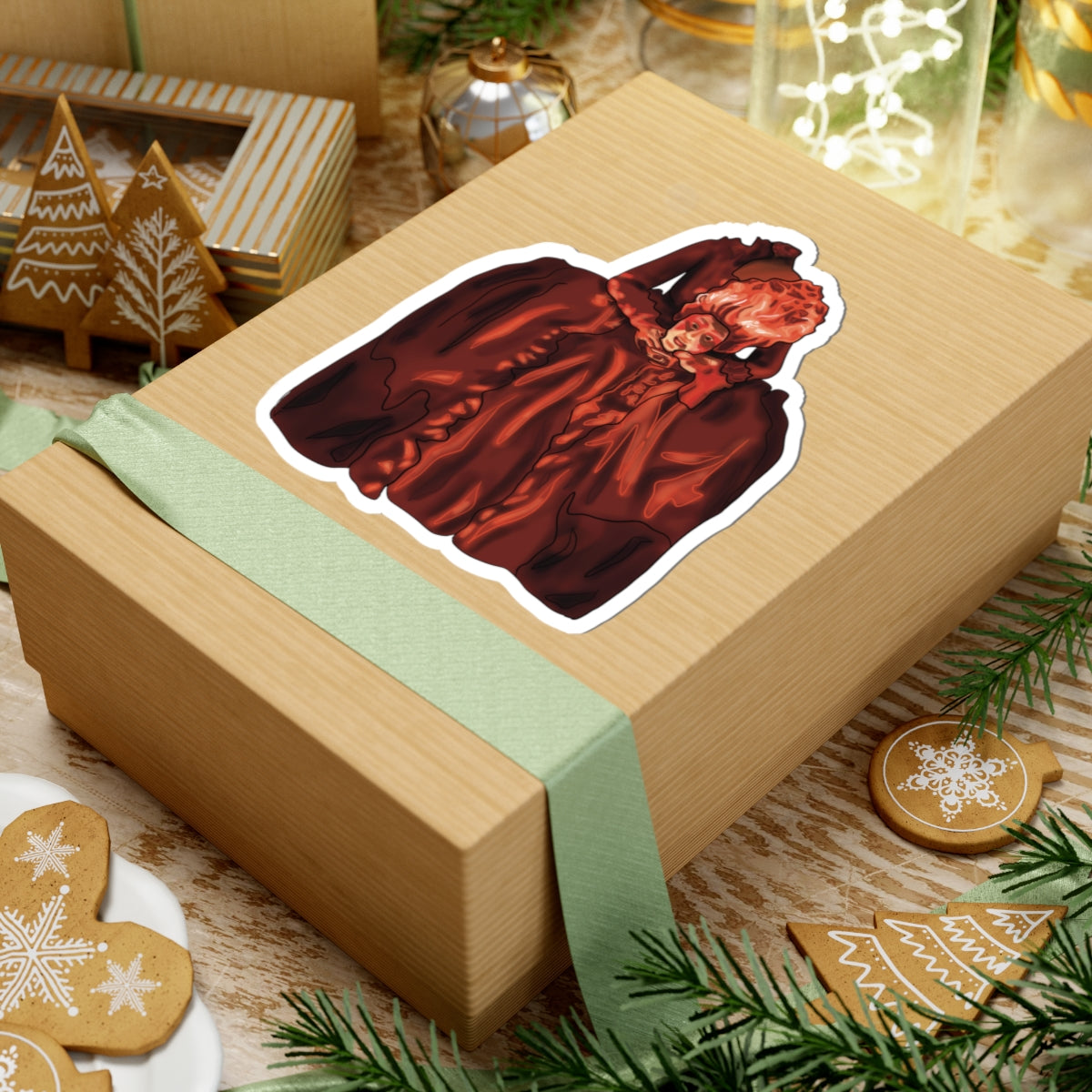 Large sticker on a package featuring a drawing of Marie Antoinette dressed in red, holding her own head after beheading.