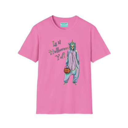 Pink t-shirt featuring a drawing of a skeleton in a unicorn costume onesie, with the phrase 'Is it Halloween yet?' printed on it.