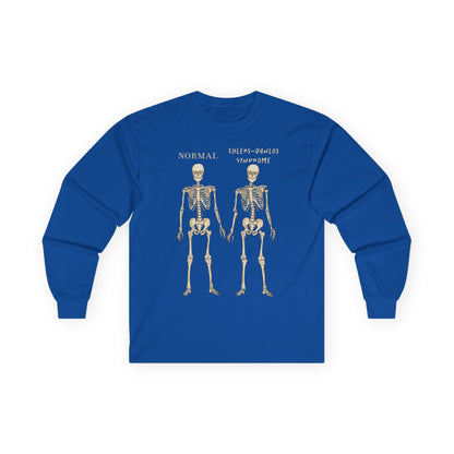 A royal blue long sleeve shirt with two skeletons side by side—one labeled "normal," the other "Ehlers-Danlos Syndrome"—visually showcasing the effects of EDS with a clever, anatomy-inspired twist.