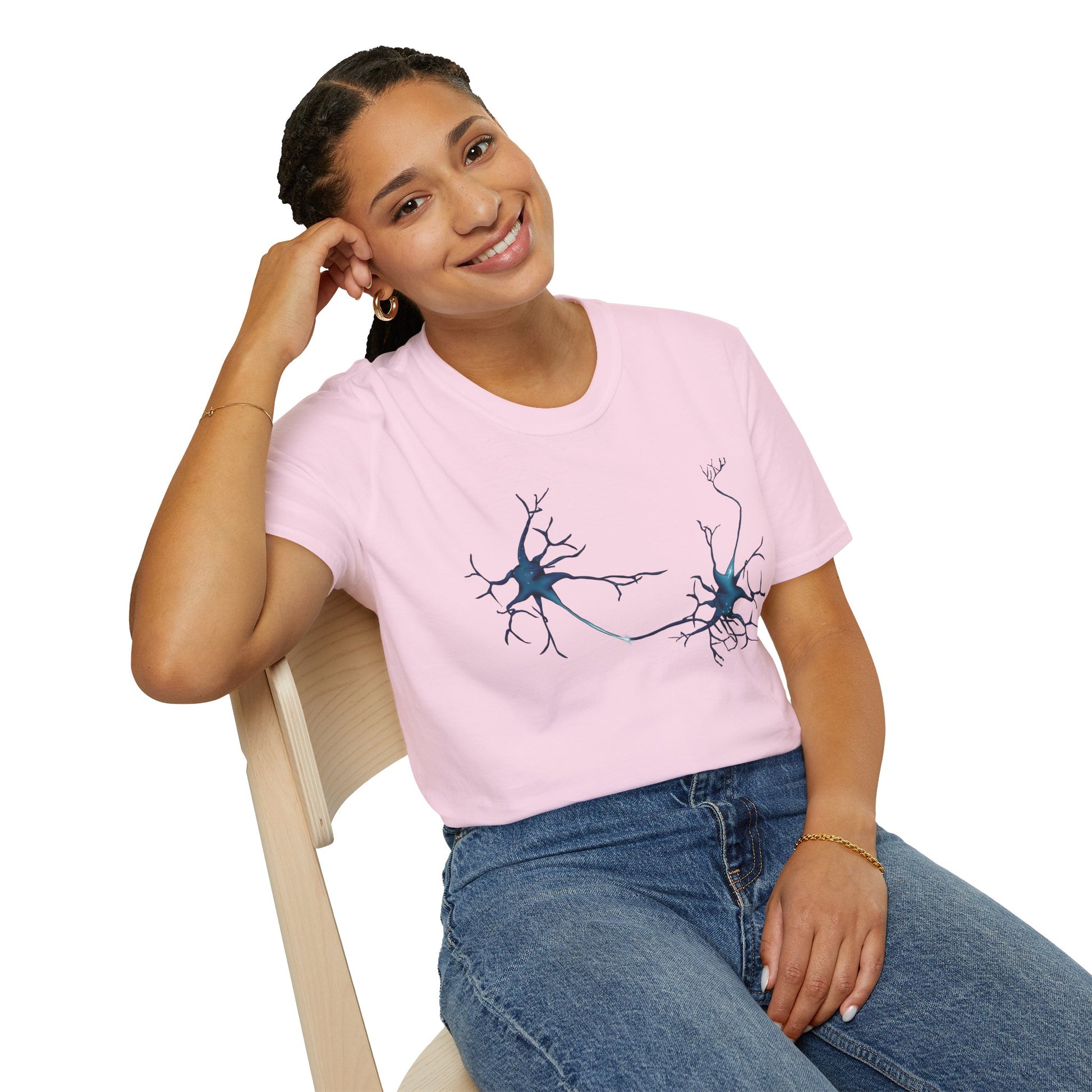 Woman wearing a light pink t-shirt featuring an illustration of two blue neurons extending toward each other and forming a synapse across the front.