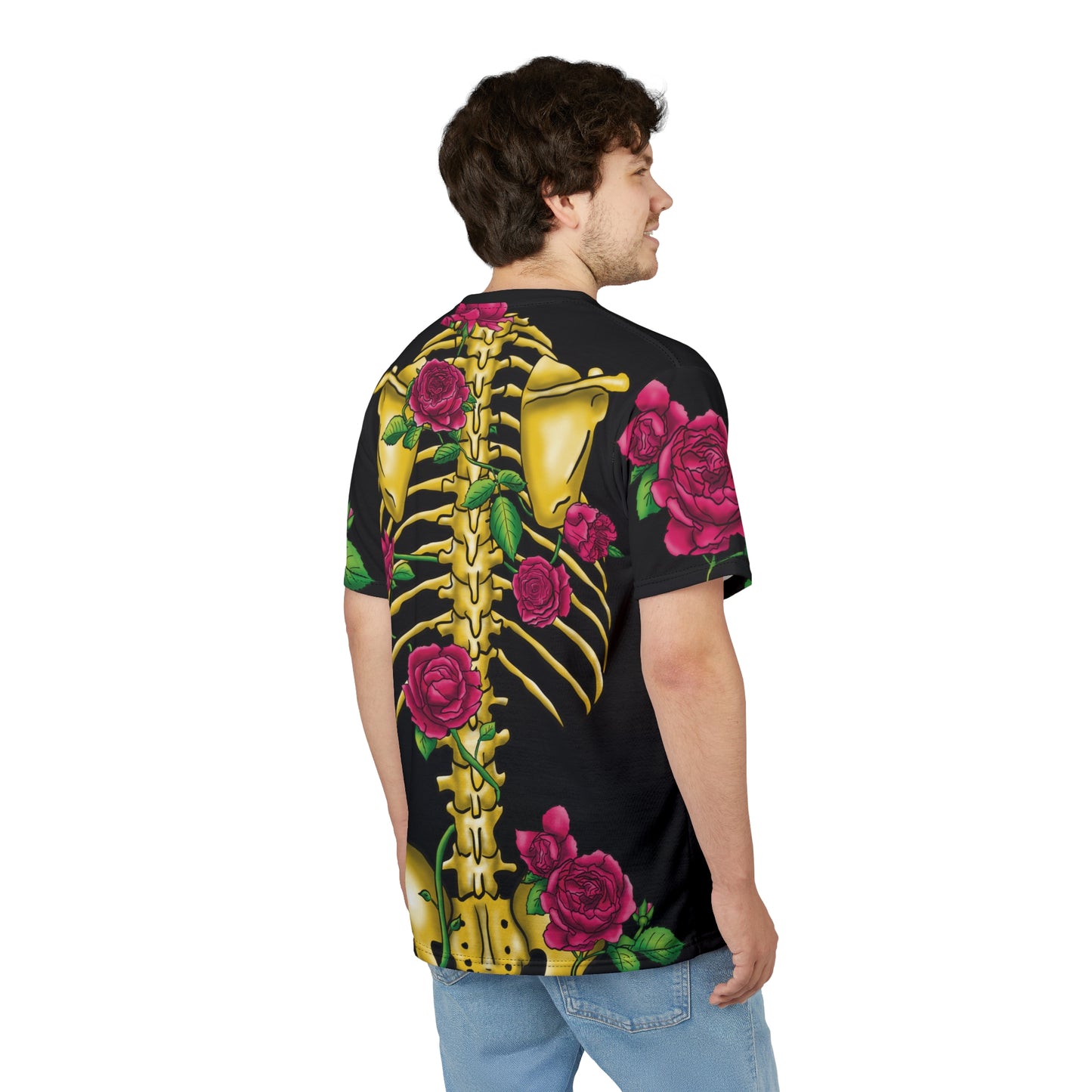 Angled view of a man wearing a unisex black athletic t-shirt featuring a gold anatomical skeleton adorned with blooming pink roses—because strength and beauty aren't mutually exclusive, and your bones deserve to blossom.