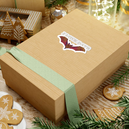 Small sticker featuring a drawing of a brown bat in flight with text that says 'I love bats.' The sticker is adhered to a gift
