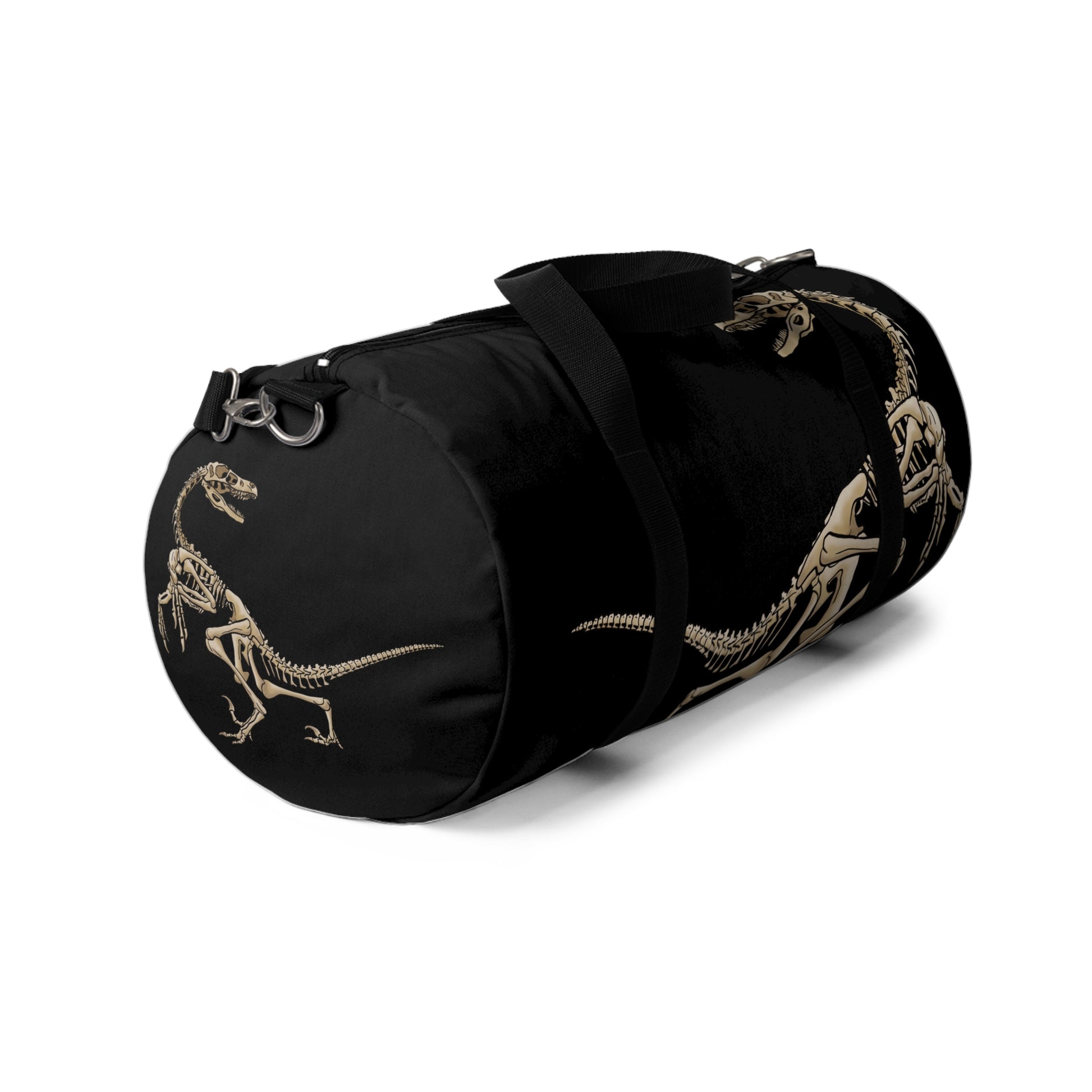 Left view of a black duffel bag with bone-beige illustrations of velociraptor skeleton fossils—perfect for carrying your gear while channeling serious prehistoric predator energy.